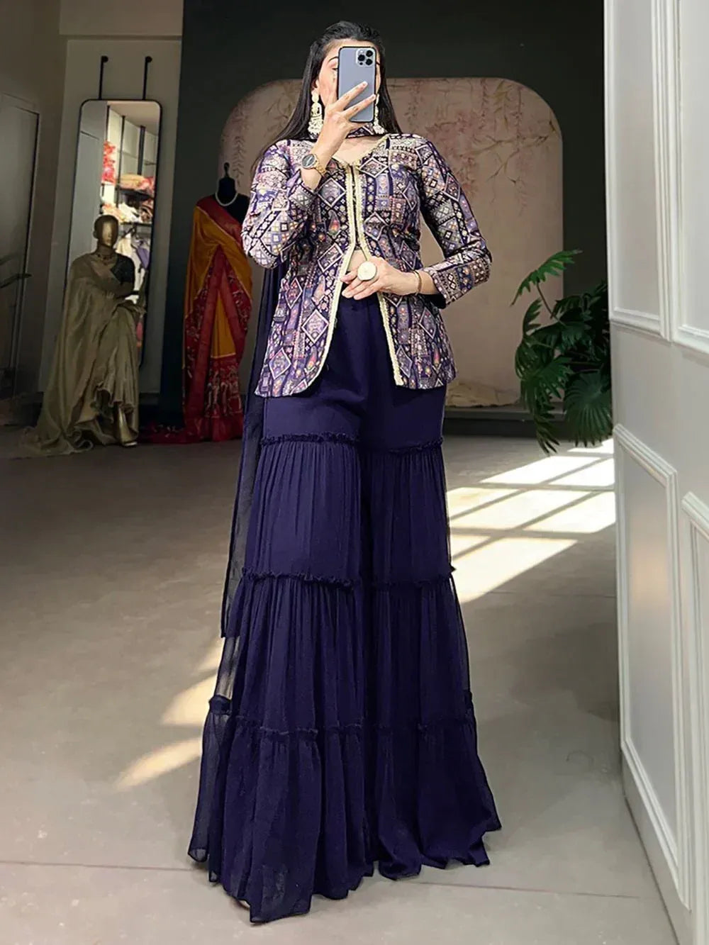 Woman in navy tiered palazzo pants with printed ethnic jacket, perfect for Indian festive wear