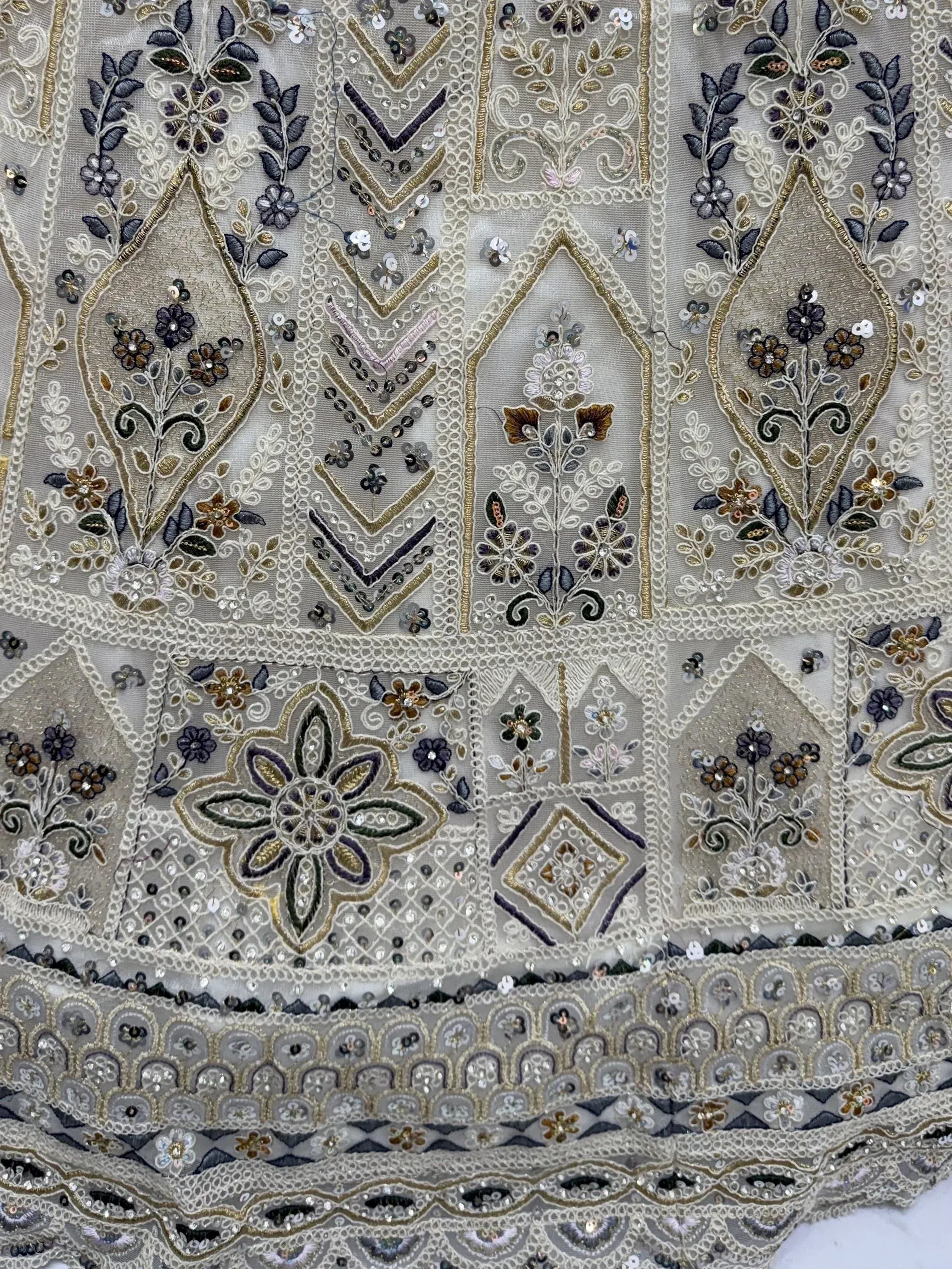 Charming Cream Embroidered Net Engagement Wear Lehenga Choli