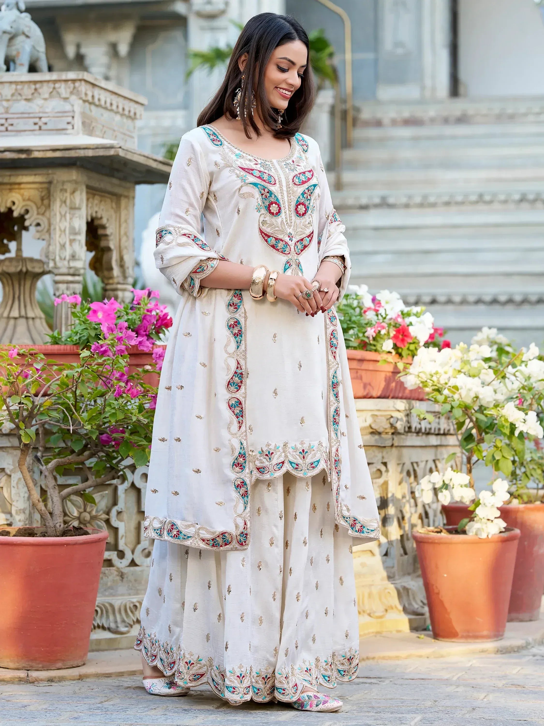 Elegant white embroidered salwar kameez with floral motifs, perfect for Indian ethnic occasions.