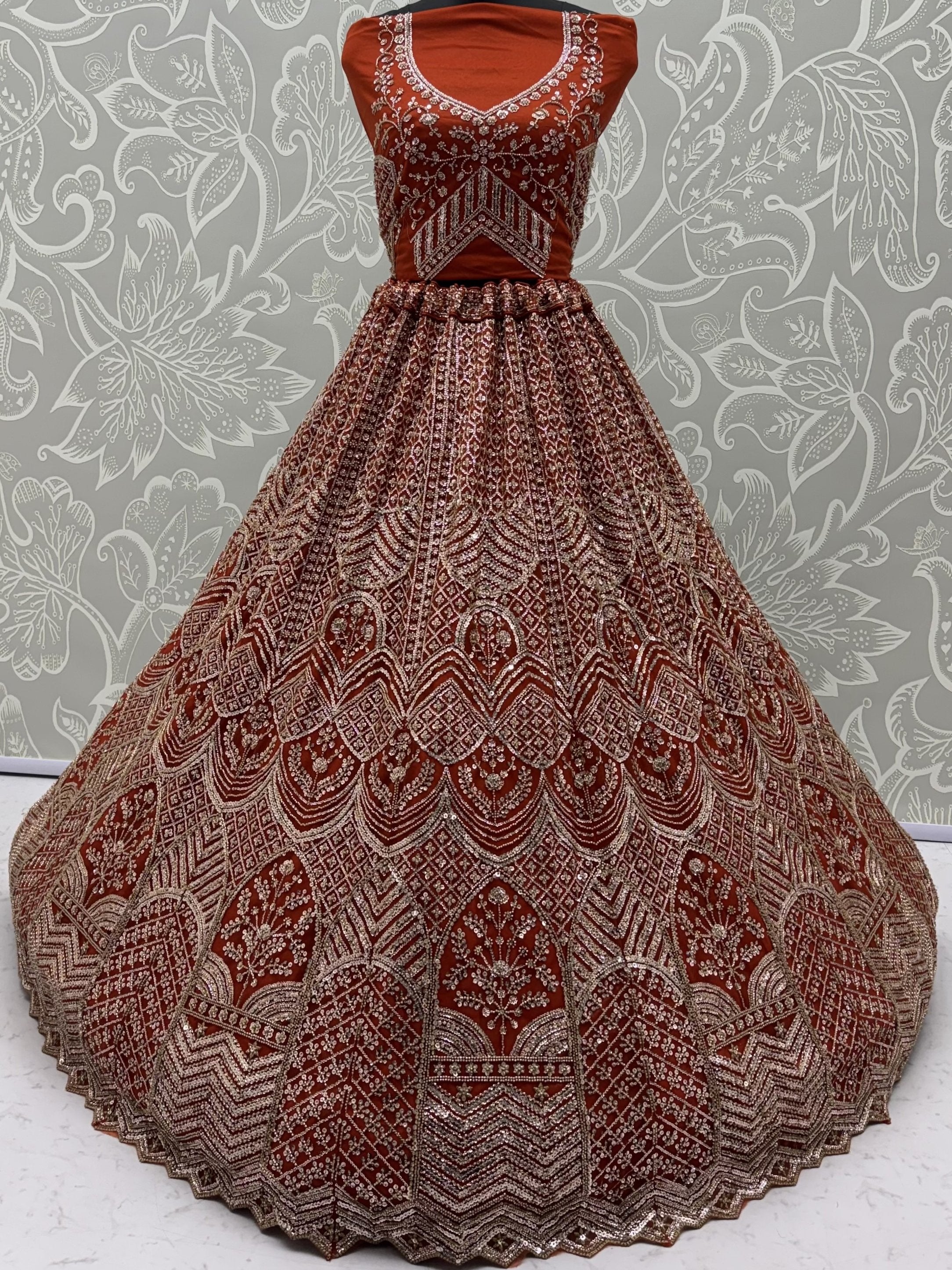 Wonderful Rust Orange Sequins Net Wedding Wear Lehenga Choli