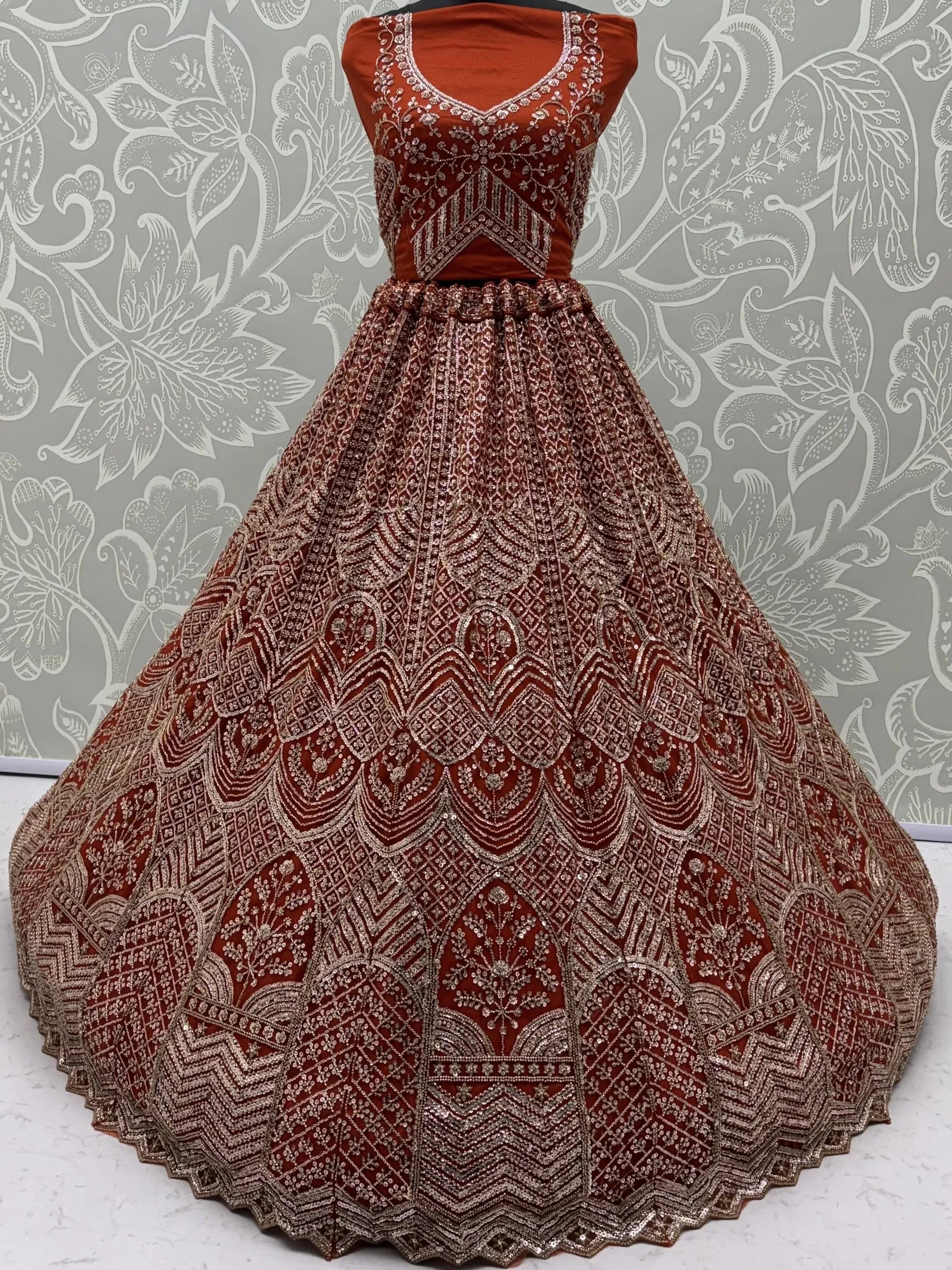 Wonderful Rust Orange Sequins Net Wedding Wear Lehenga Choli