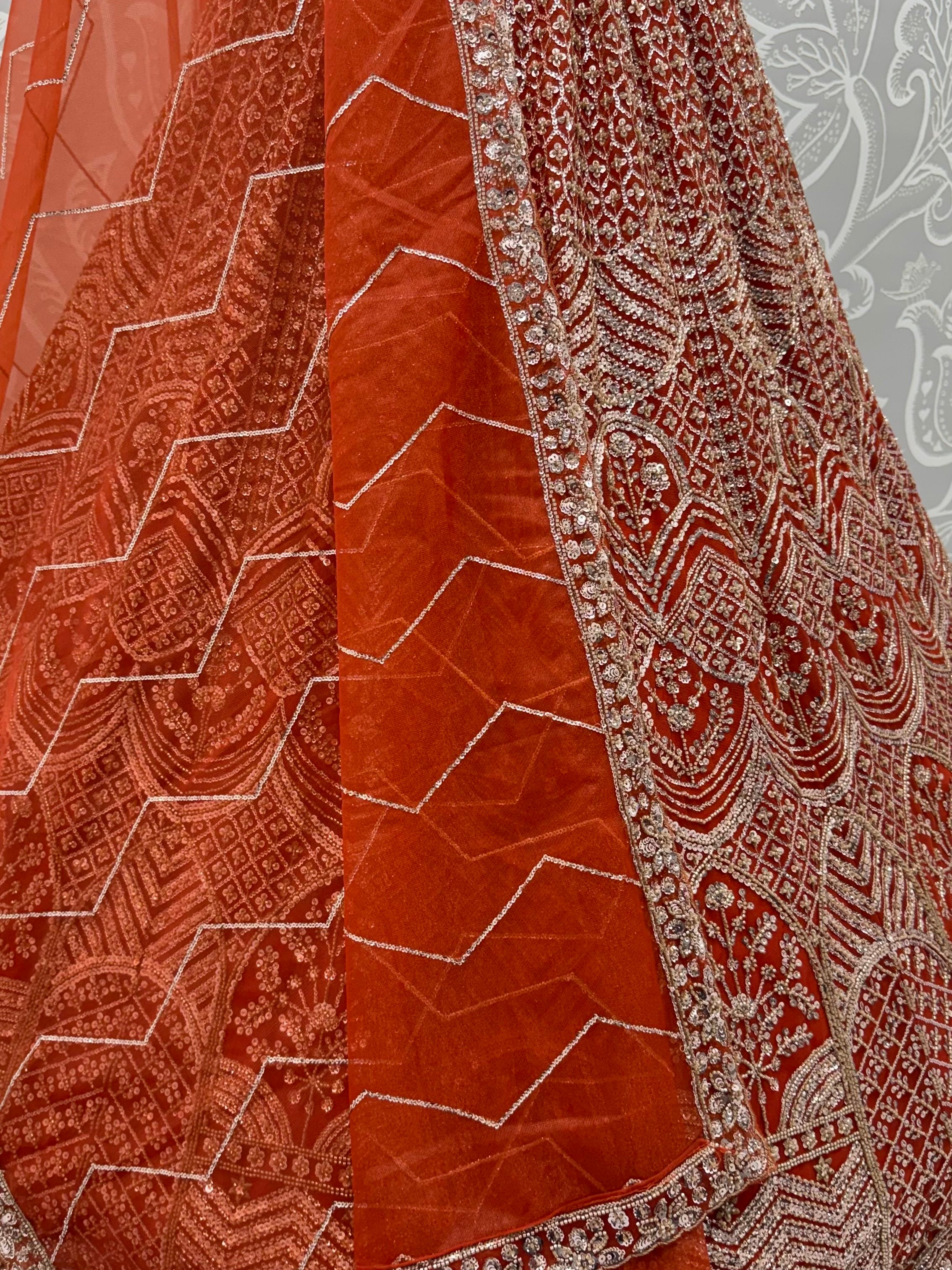 Wonderful Rust Orange Sequins Net Wedding Wear Lehenga Choli