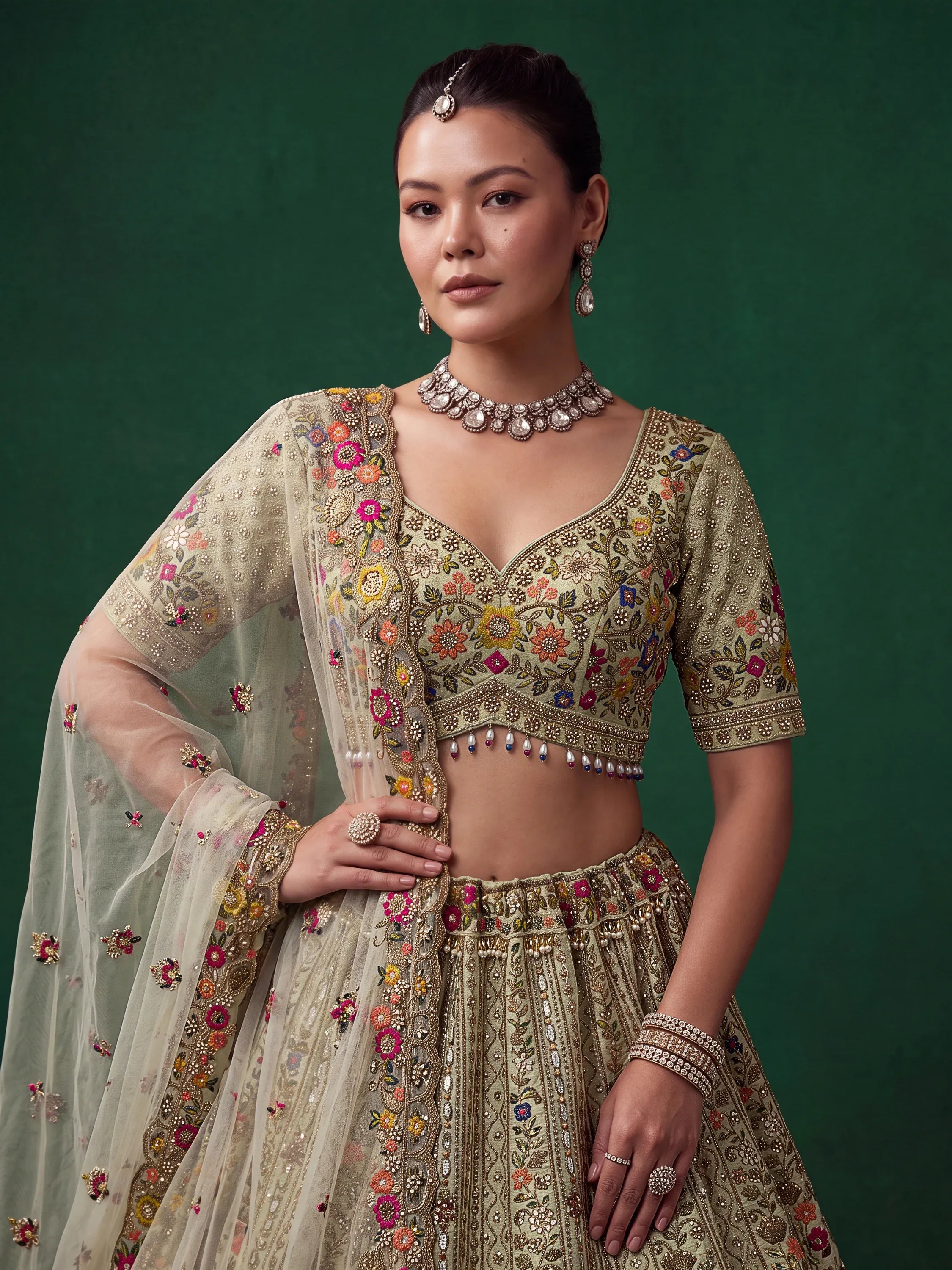 Luxurious Pista Green Hand Embroidered Silk Reception Wear Lehenga Choli