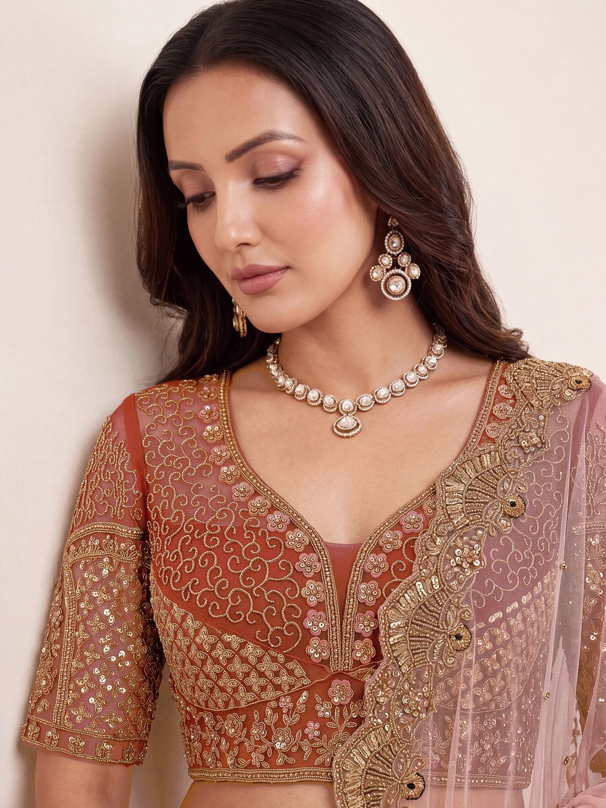 Regal Rust Pink Zircon Work Net Wedding Wear Lehenga With Blouse