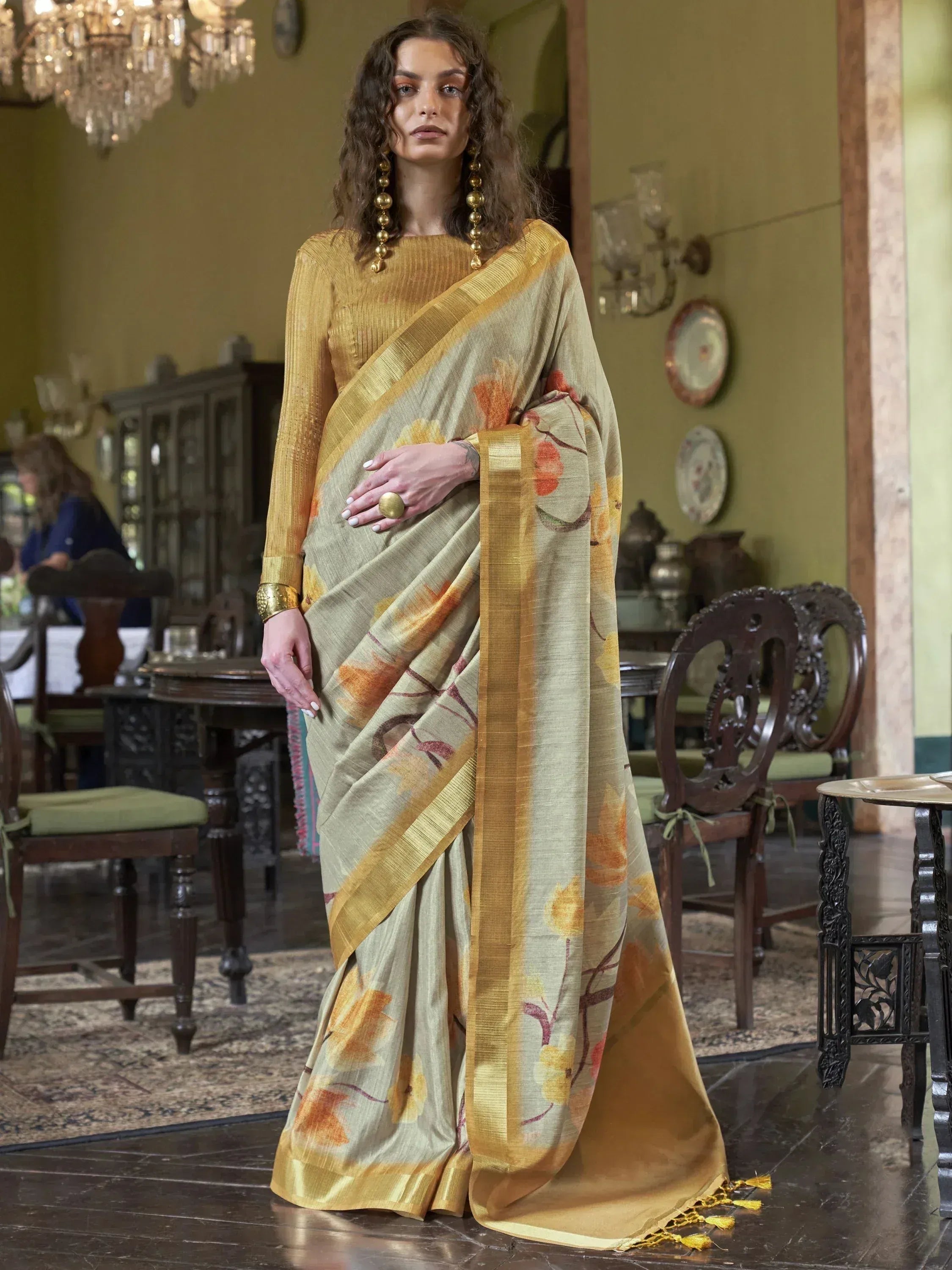 Elegant floral print saree with golden border, paired with matching blouse, perfect for ethnic occasions.