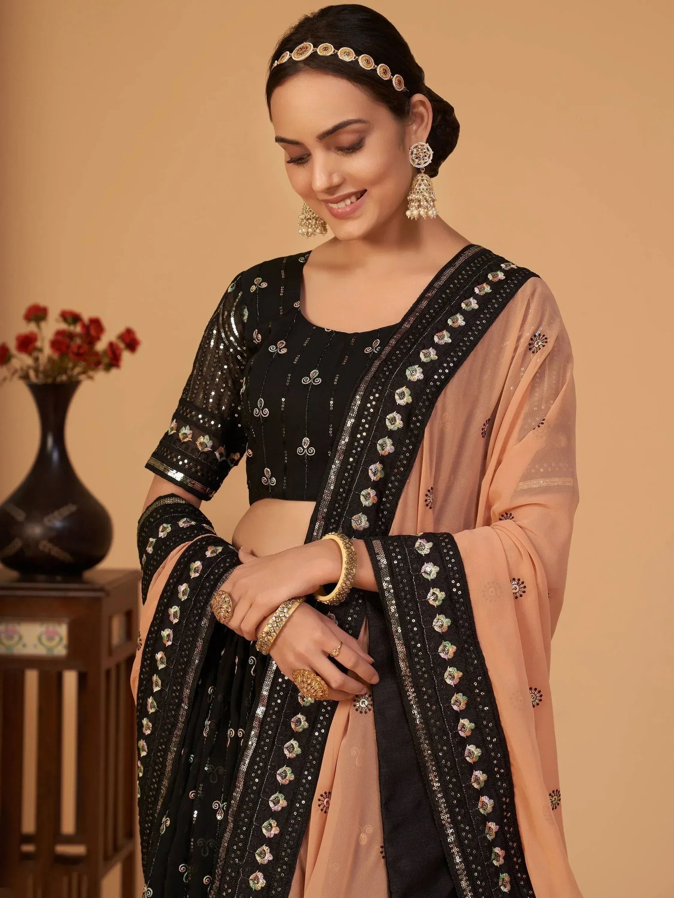 Black embroidered lehenga choli with peach dupatta, perfect for Indian ethnic wear occasions