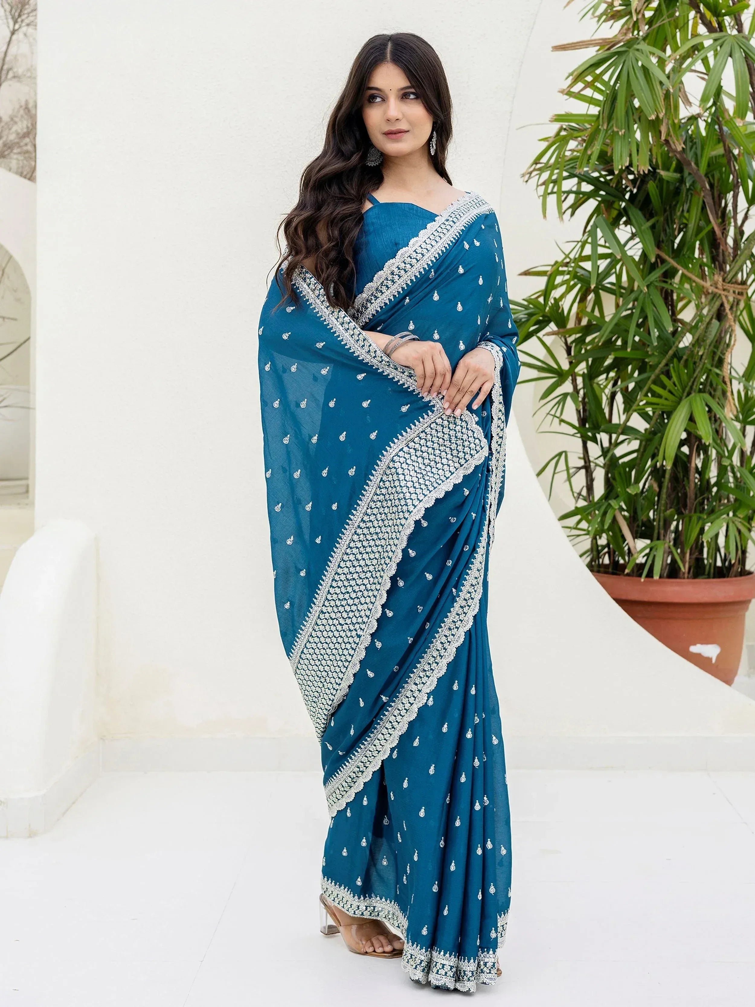 Teal blue embroidered saree with silver border, perfect for Indian ethnic wear occasions