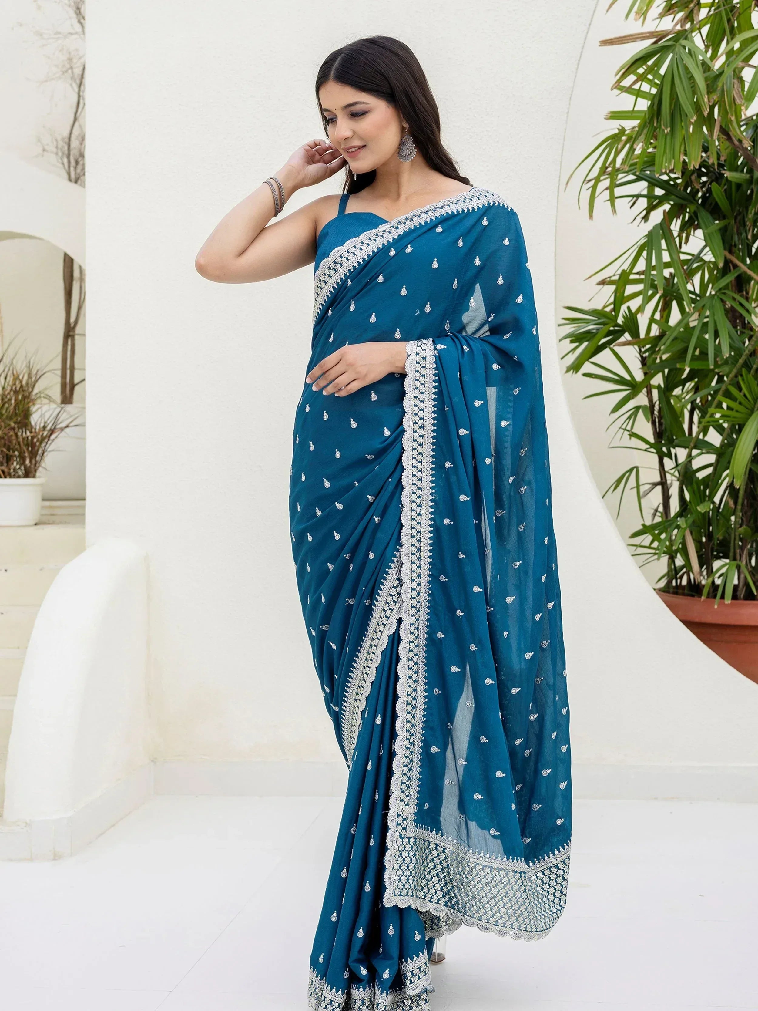 Teal saree with silver embroidery, perfect for ethnic wear and festive occasions.