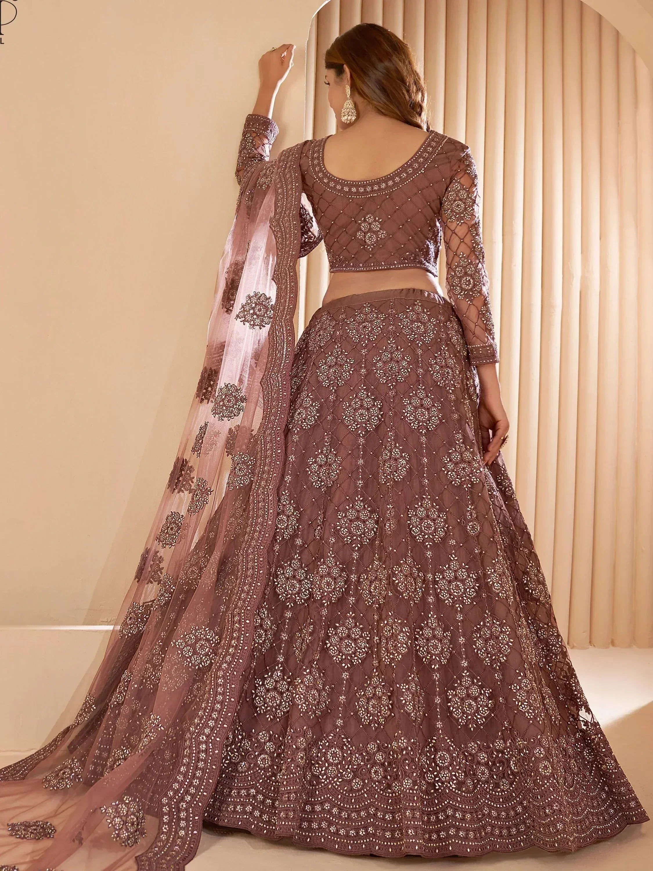 Elegant mauve lehenga choli with intricate embroidery and sheer dupatta, perfect for Indian ethnic occasions.