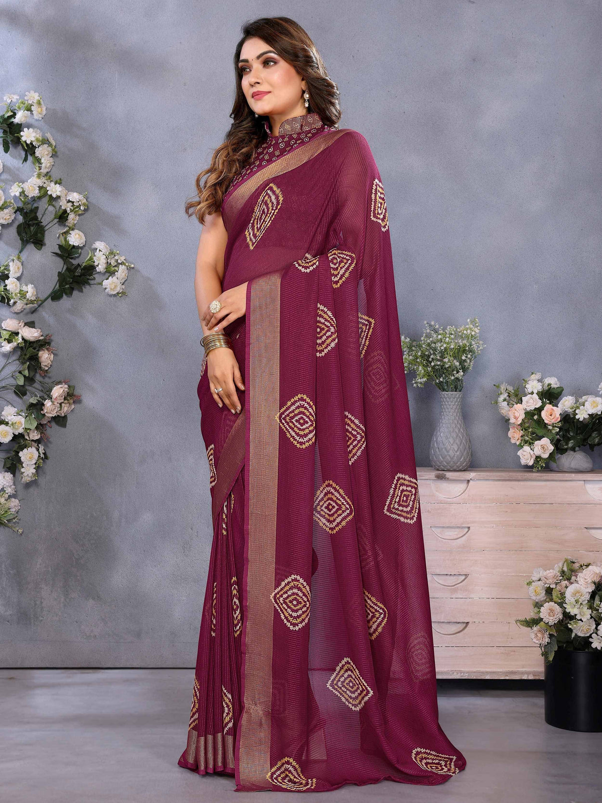 Maroon ethnic saree with gold geometric embroidery and matching blouse, ideal for Indian occasions