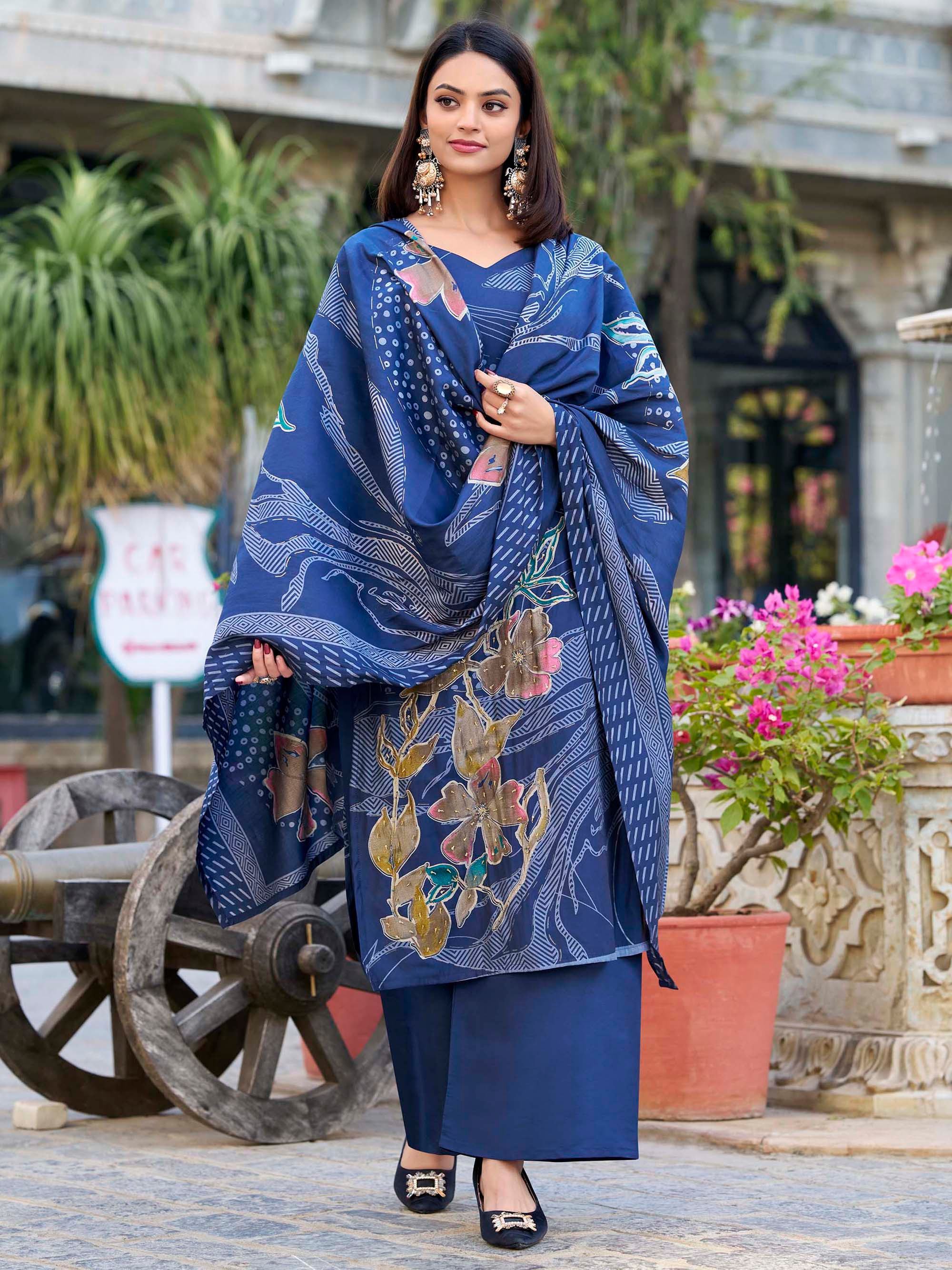 Woman in blue printed ethnic salwar kameez with dupatta, floral design, outdoor setting