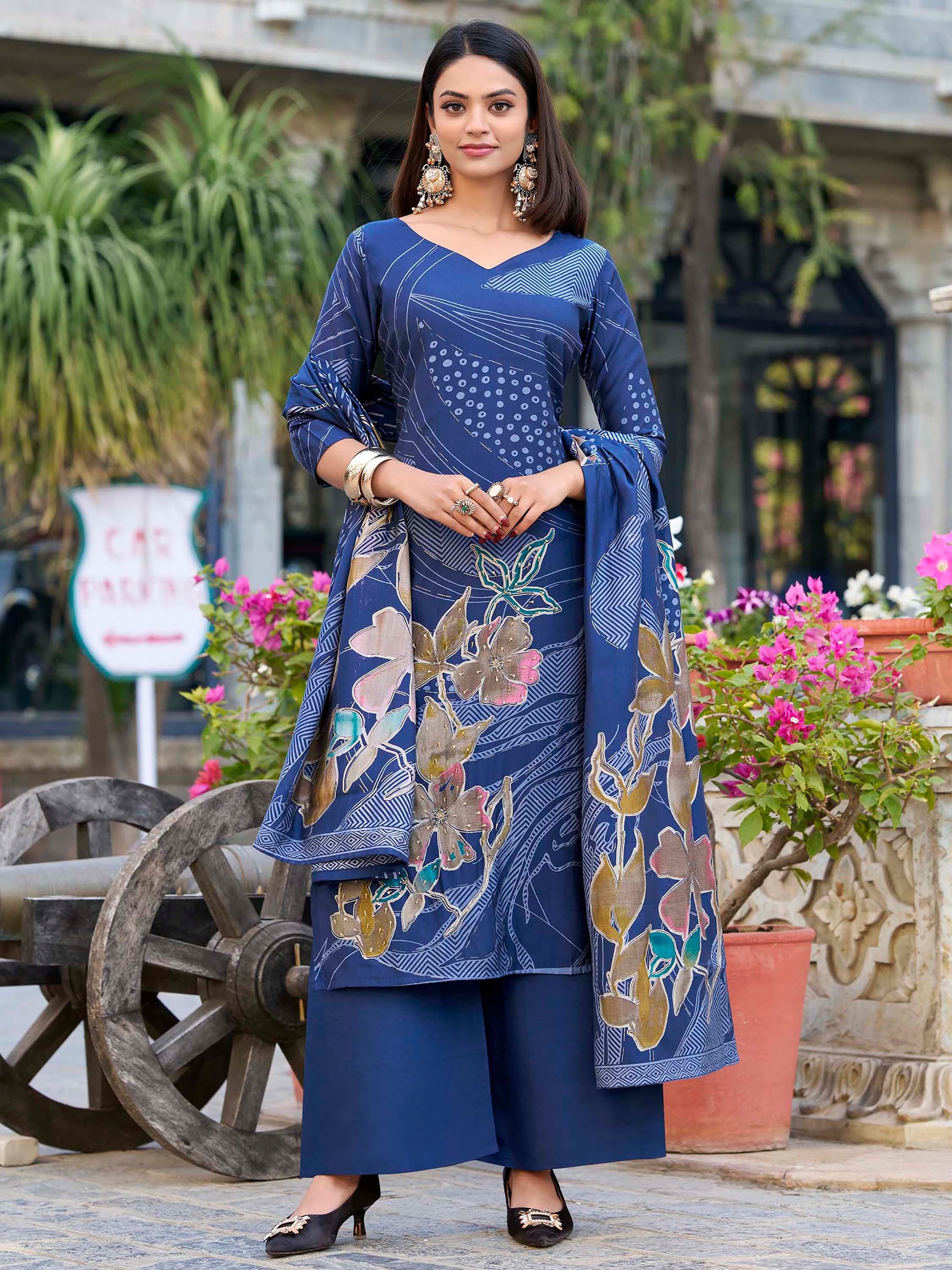 Woman in navy blue floral salwar kameez with matching dupatta, outdoor Indian setting