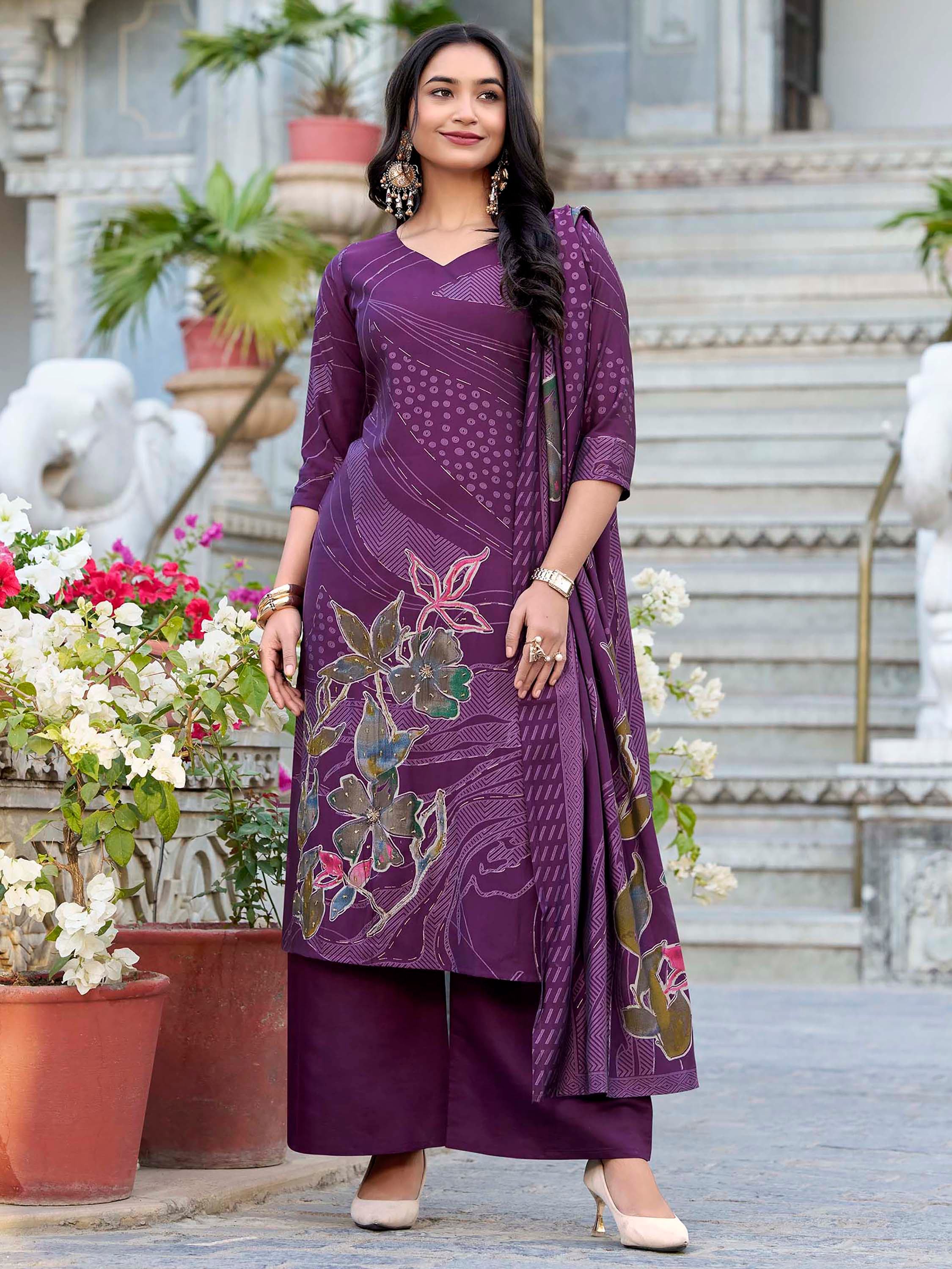 Woman in purple printed salwar kameez set with floral patterns, traditional Indian ethnic wear