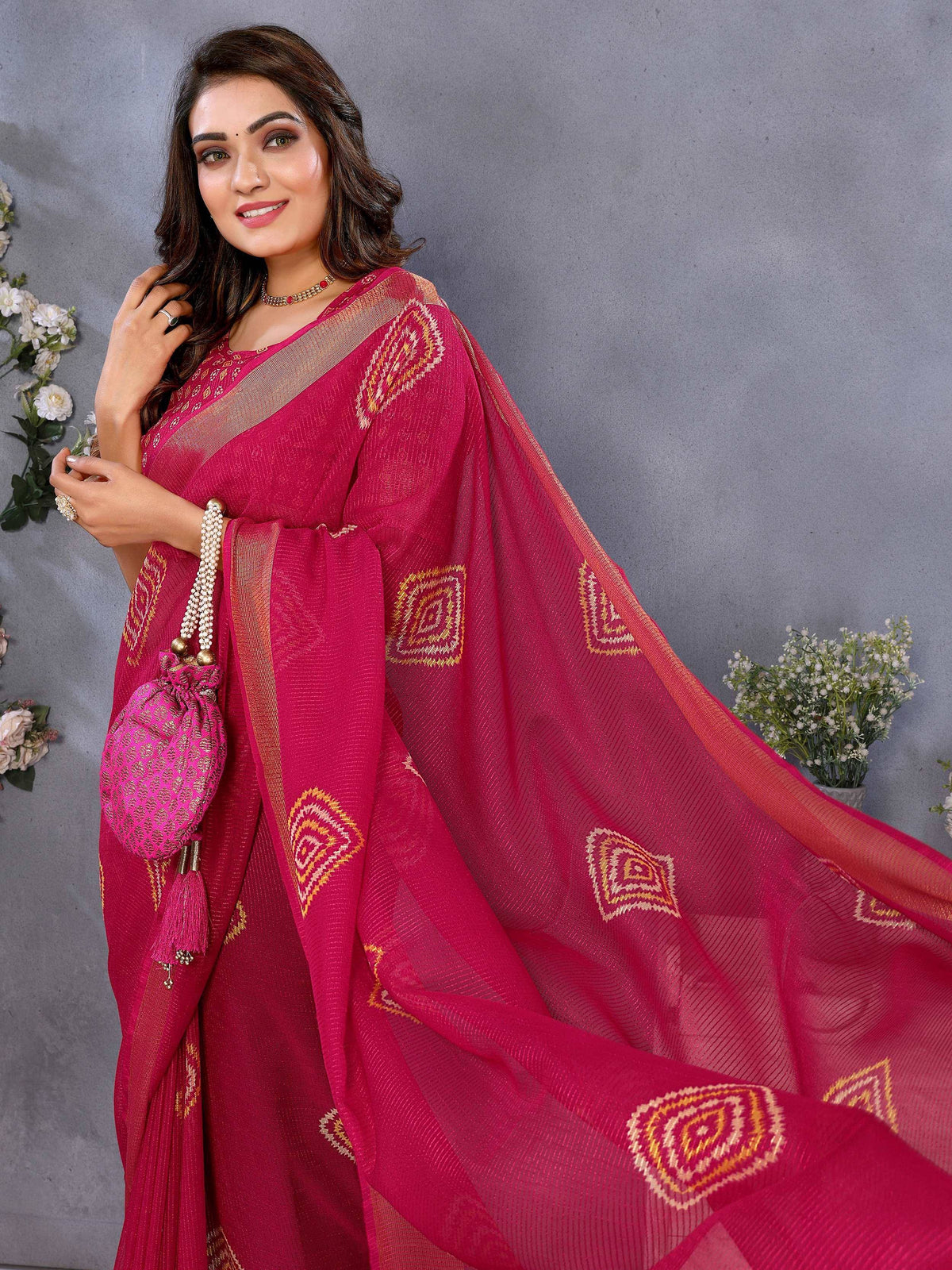 Woman in vibrant pink ethnic saree with gold geometric embroidery, perfect for Indian occasions