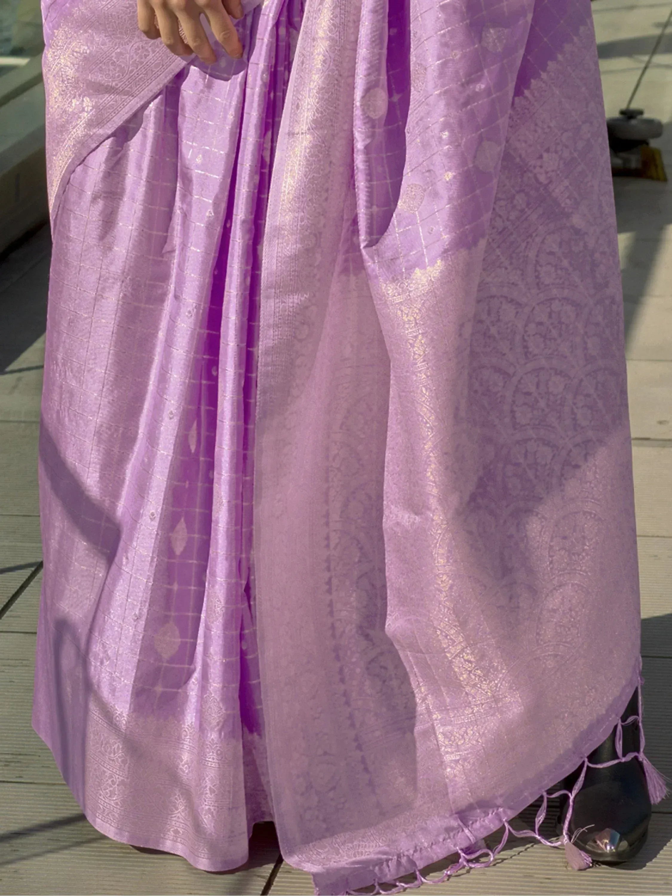 Lavender ethnic saree with gold zari work and tassels, perfect for Indian occasions