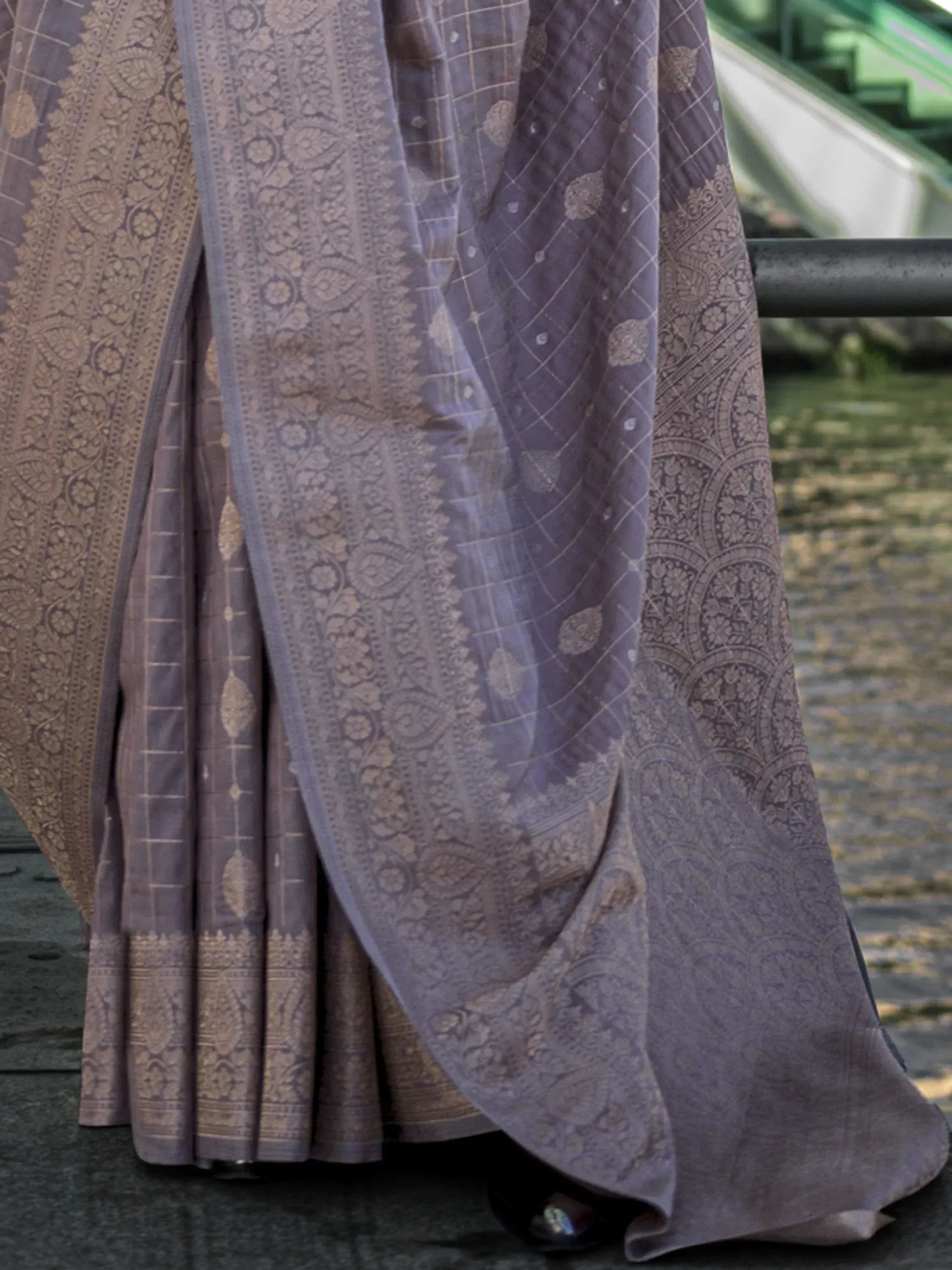 Elegant grey saree with intricate gold paisley and geometric patterns, perfect for ethnic occasions.