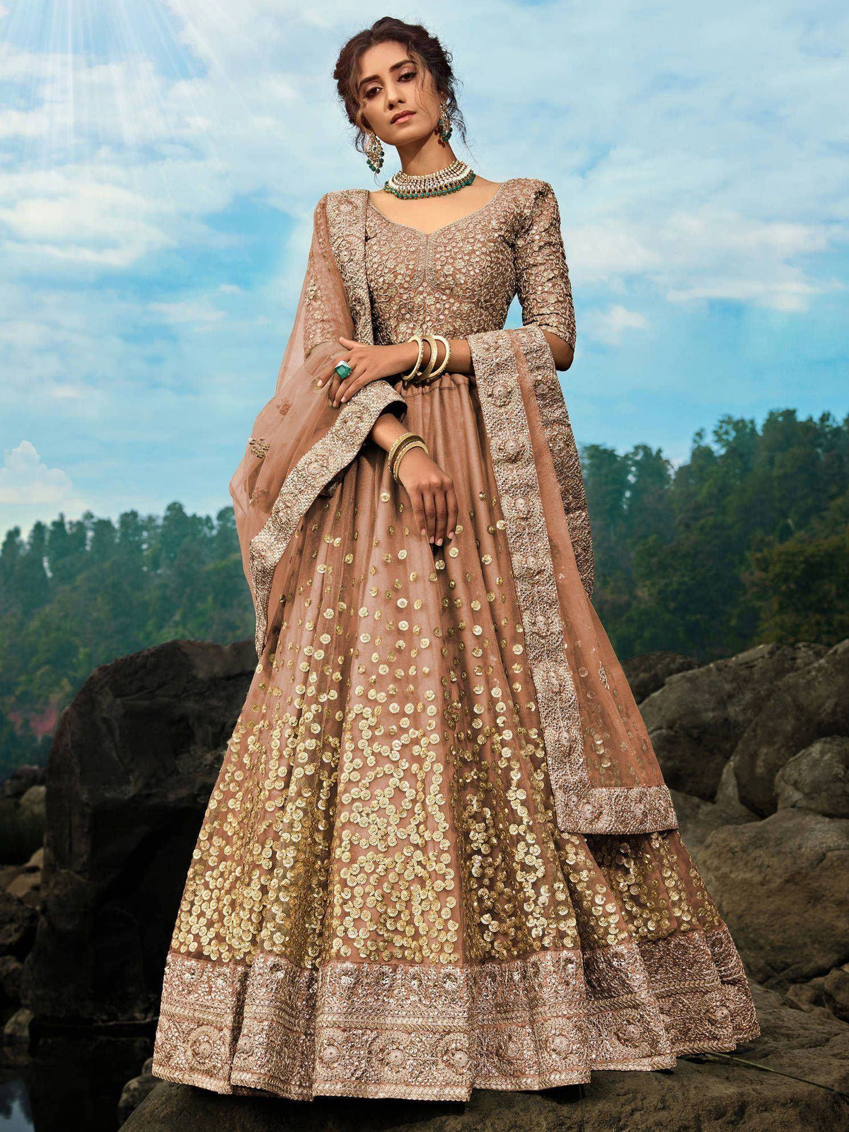 Elegant beige lehenga choli with gold embroidery, perfect for Indian weddings and festive occasions.