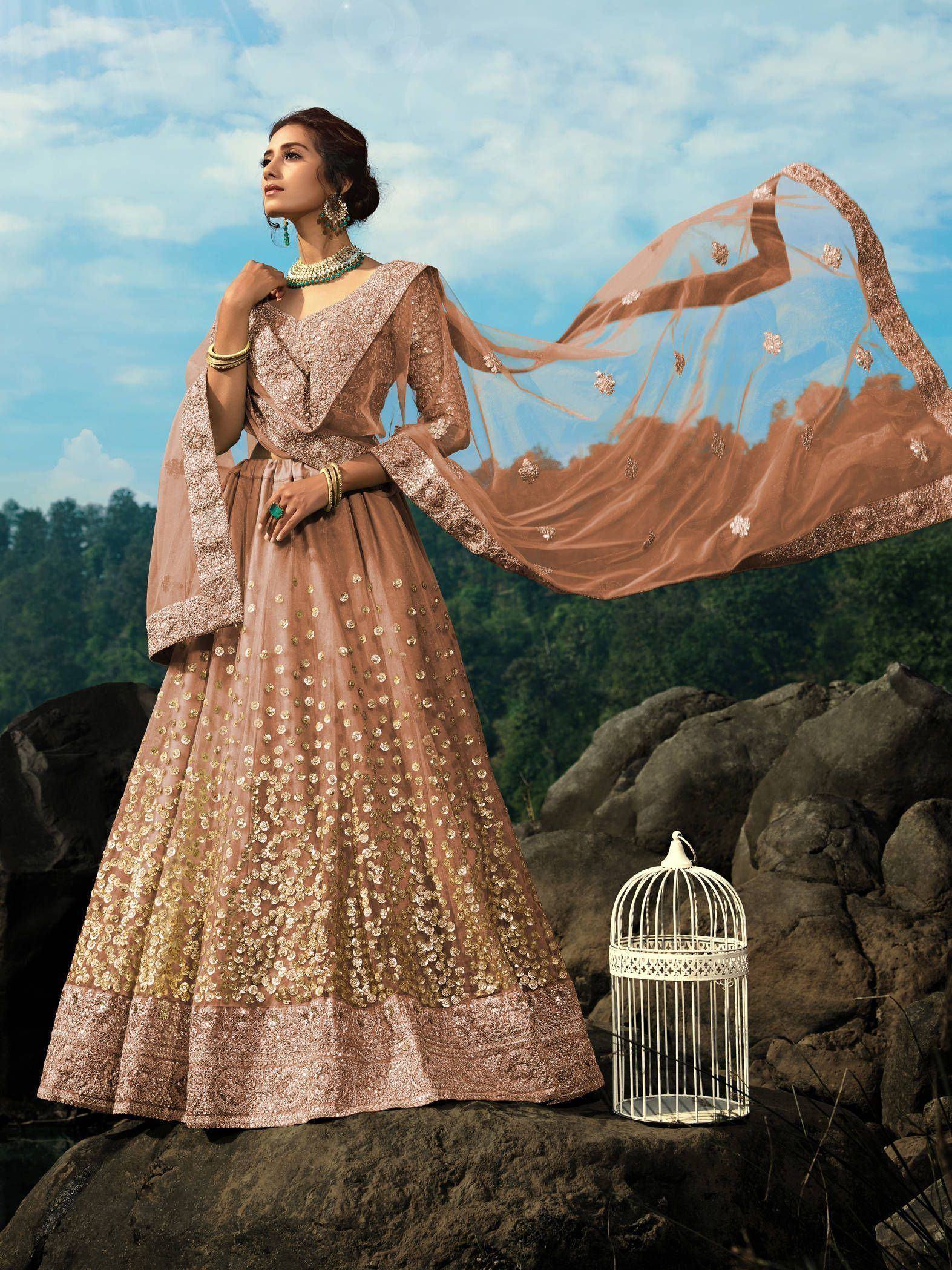 Elegant beige lehenga choli with gold embroidery, perfect for Indian weddings and festive occasions.