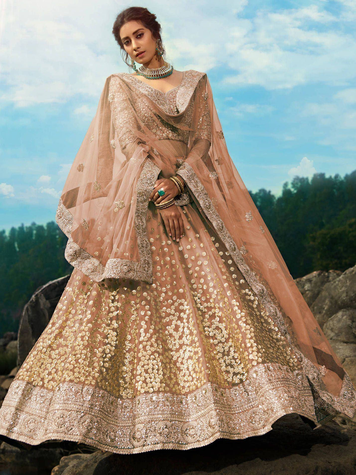 Elegant beige lehenga choli with gold sequins and embroidery, perfect for Indian weddings and festive occasions.