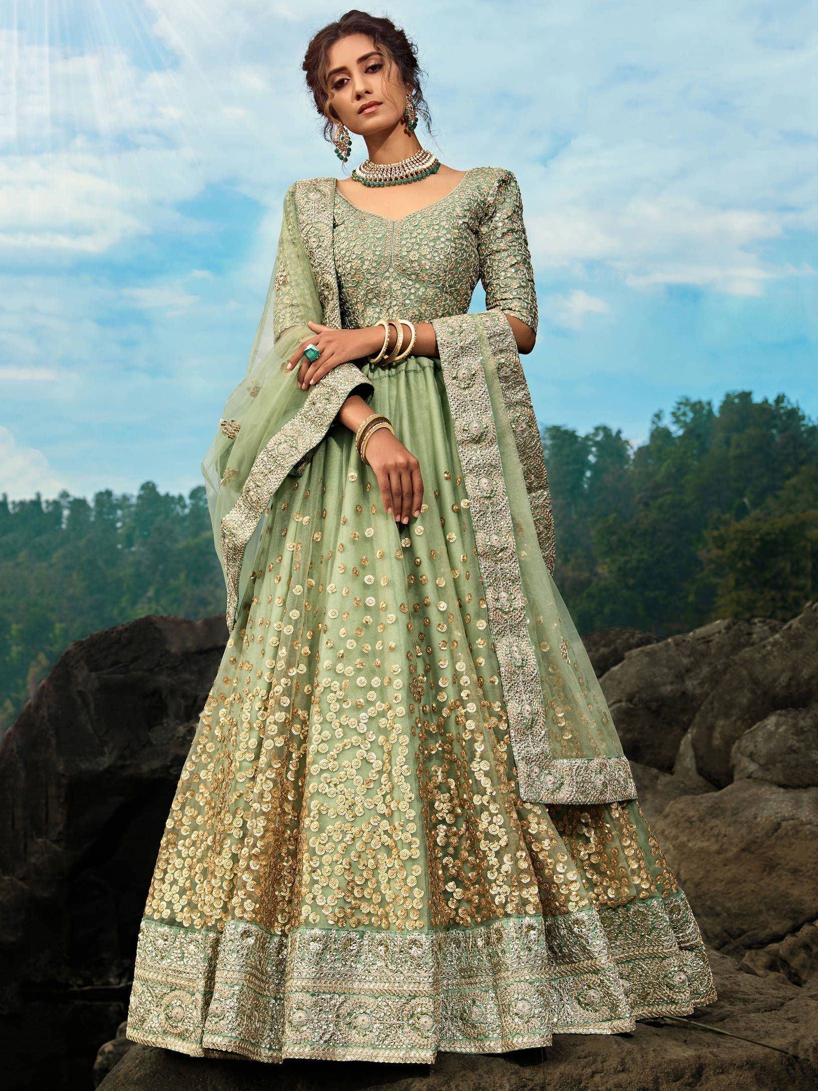 Mint green designer lehenga choli with gold embroidery, perfect for weddings and festive occasions.