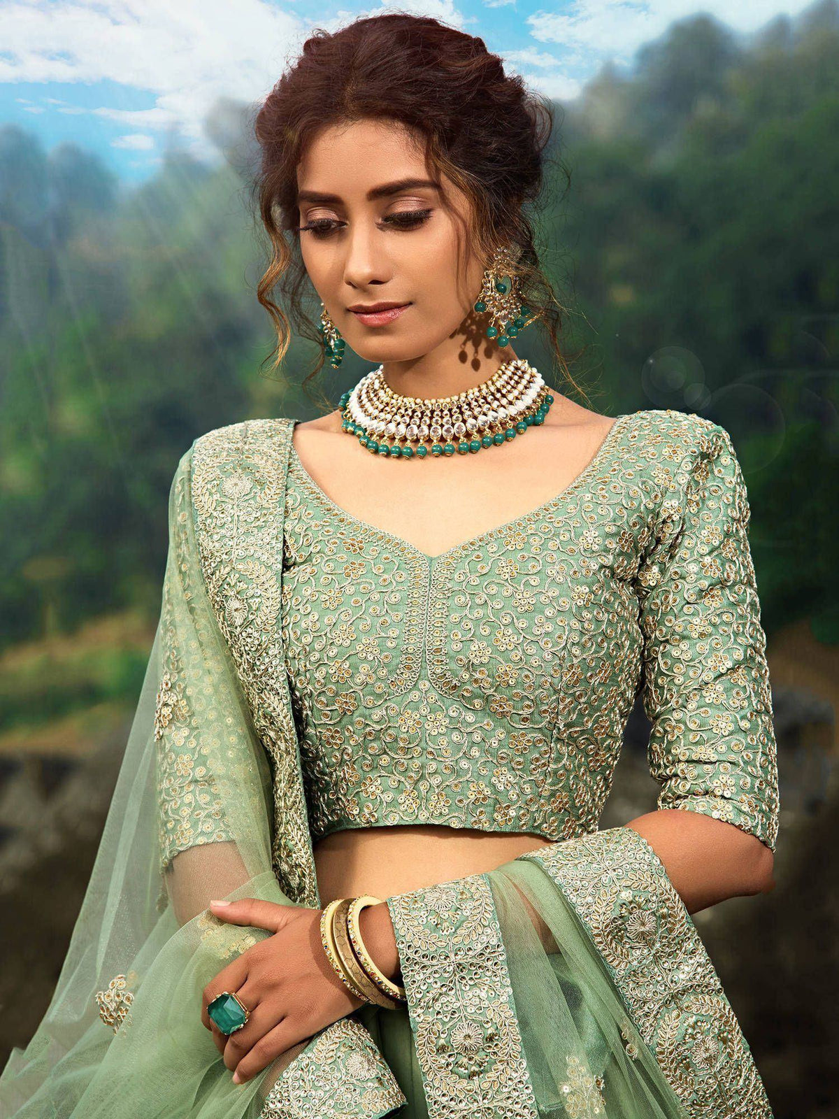 Mint green embroidered lehenga choli with gold detailing, perfect for Indian ethnic wear and festive occasions.
