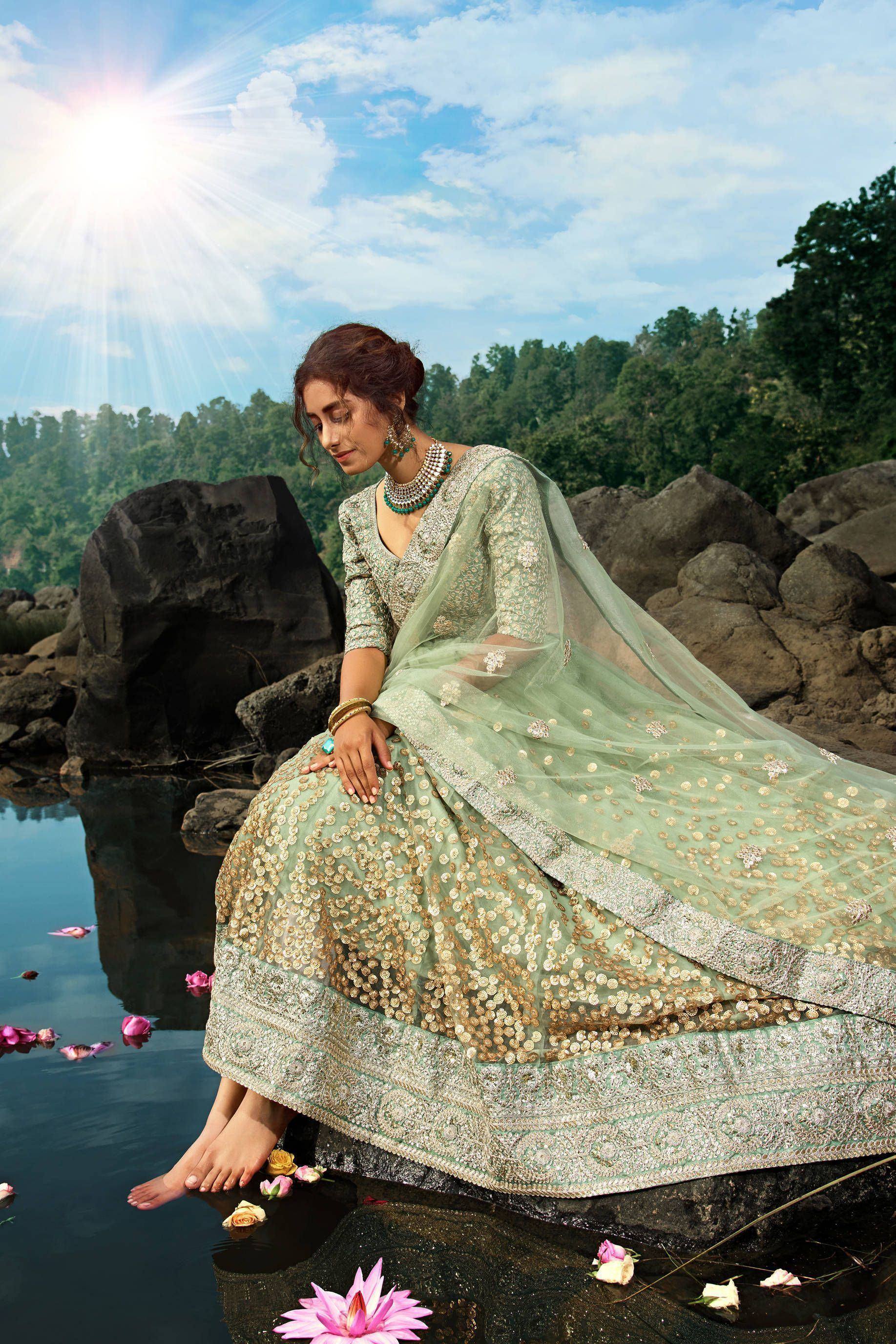 Mint green designer lehenga choli with gold embroidery, perfect for Indian weddings and festive occasions.