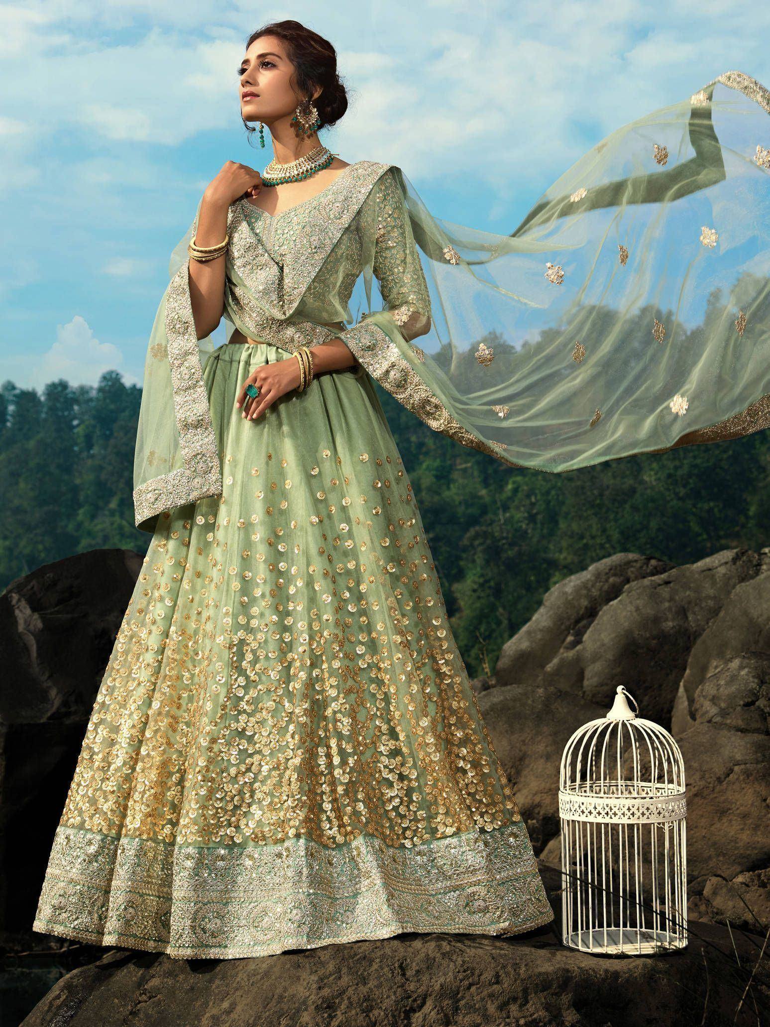 Mint green designer lehenga choli with gold embroidery, perfect for Indian ethnic wear occasions.