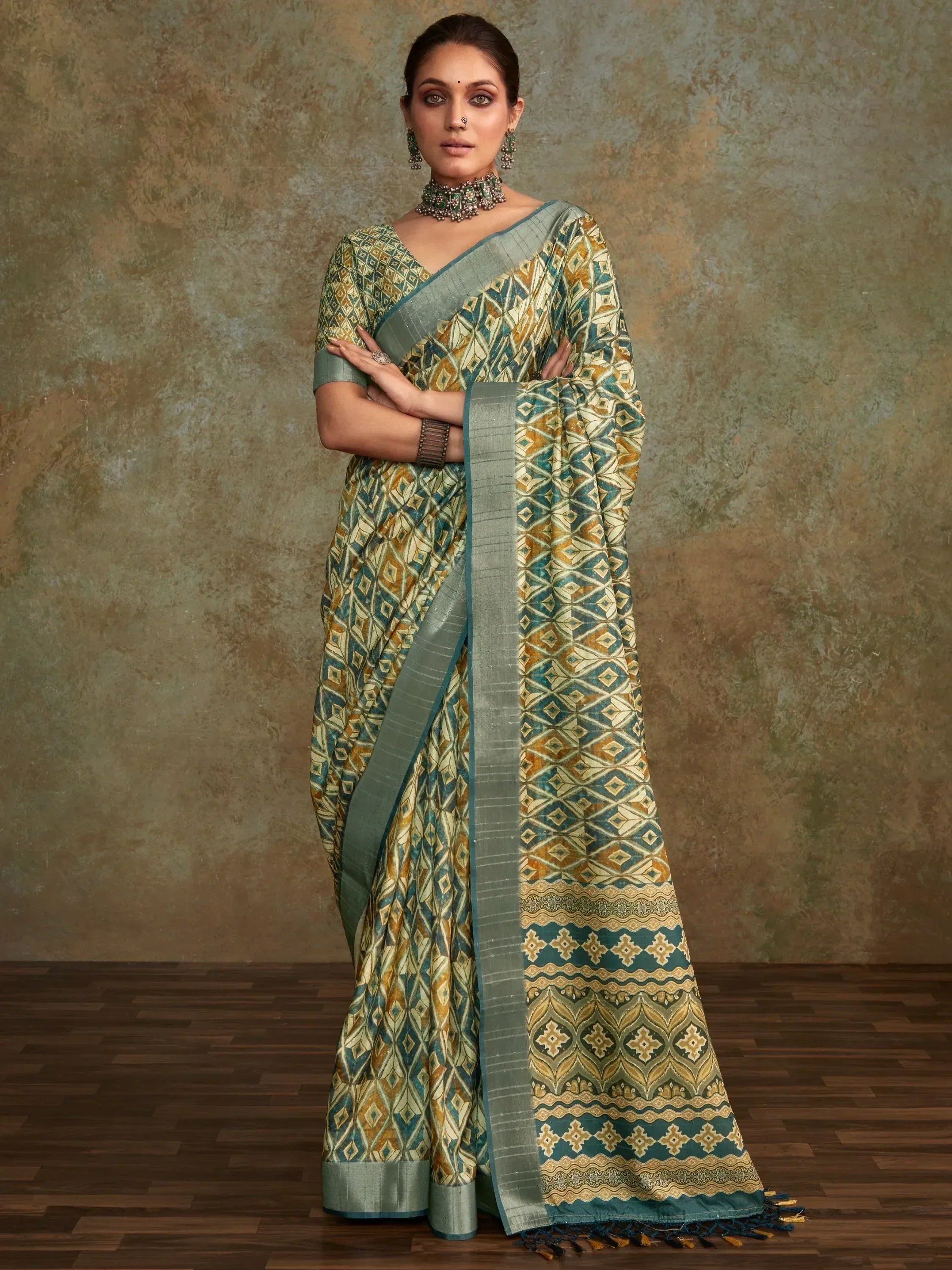 Woman in elegant green and gold printed saree with geometric pattern, traditional Indian ethnic wear