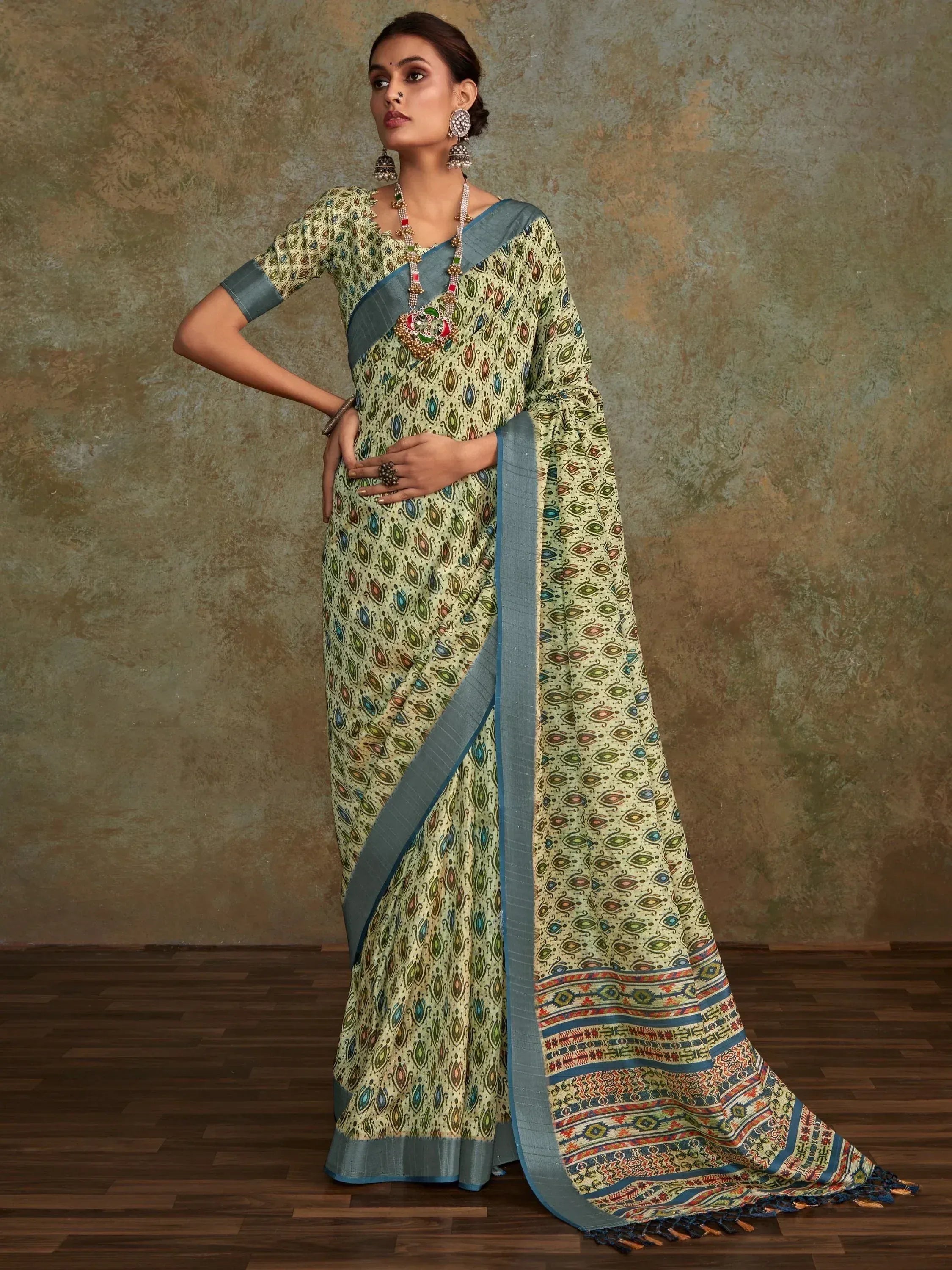 Woman in printed ethnic saree with blue border, traditional Indian wear for festive occasions