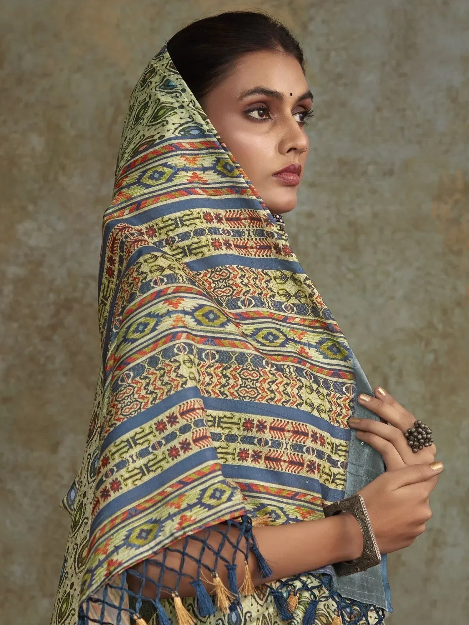 Woman wearing traditional Indian dupatta with intricate geometric patterns and tassels, styled for ethnic wear.