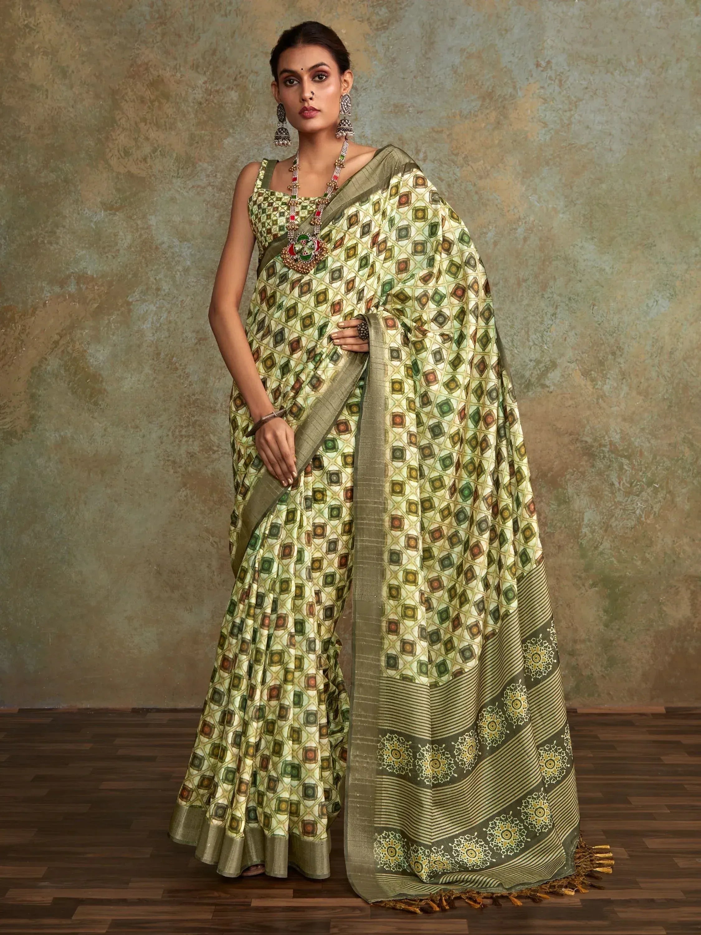 Woman in green printed saree with geometric pattern, ethnic wear for festive occasions
