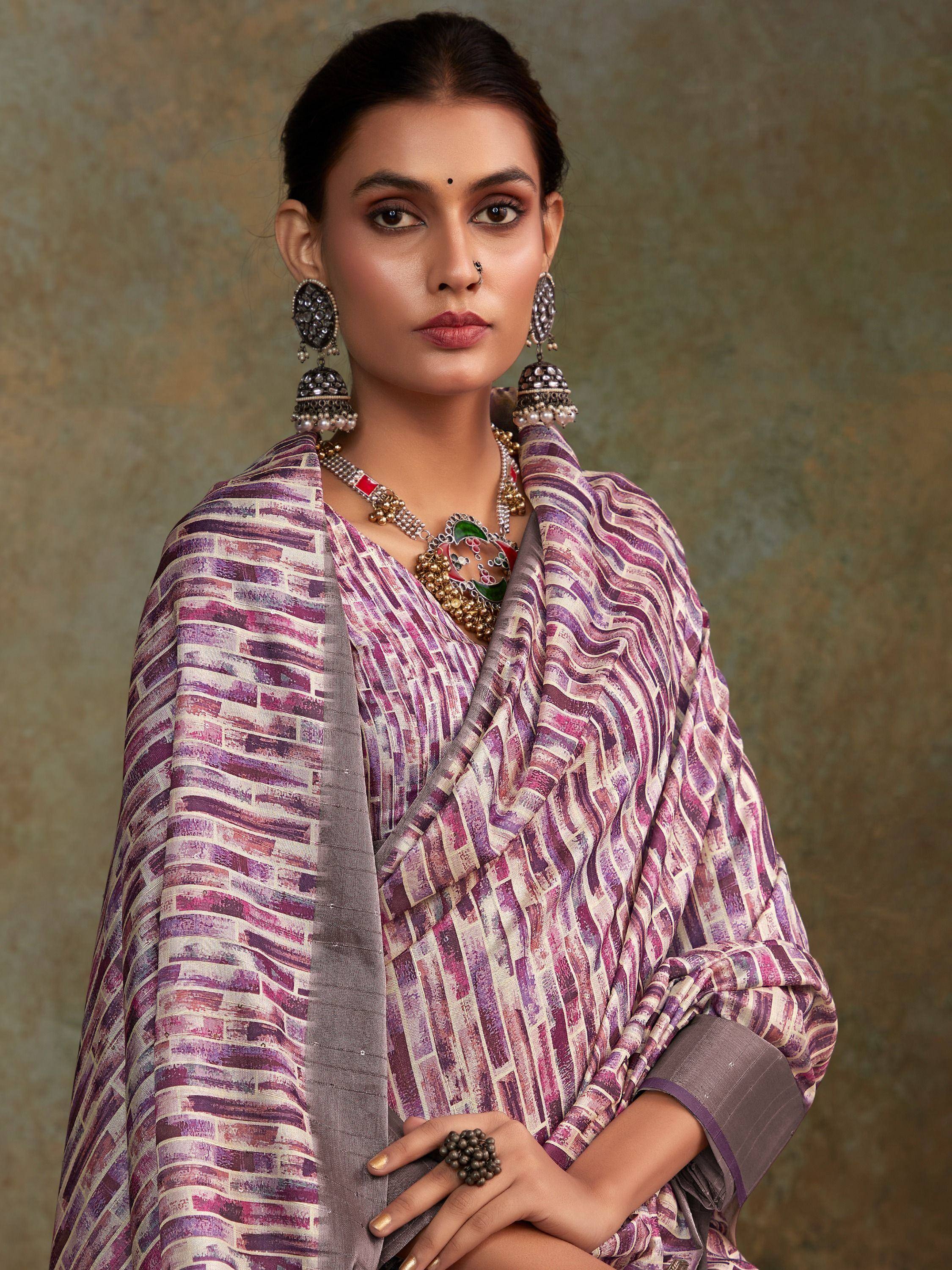 Woman in purple printed saree with traditional jewelry, ethnic Indian wear