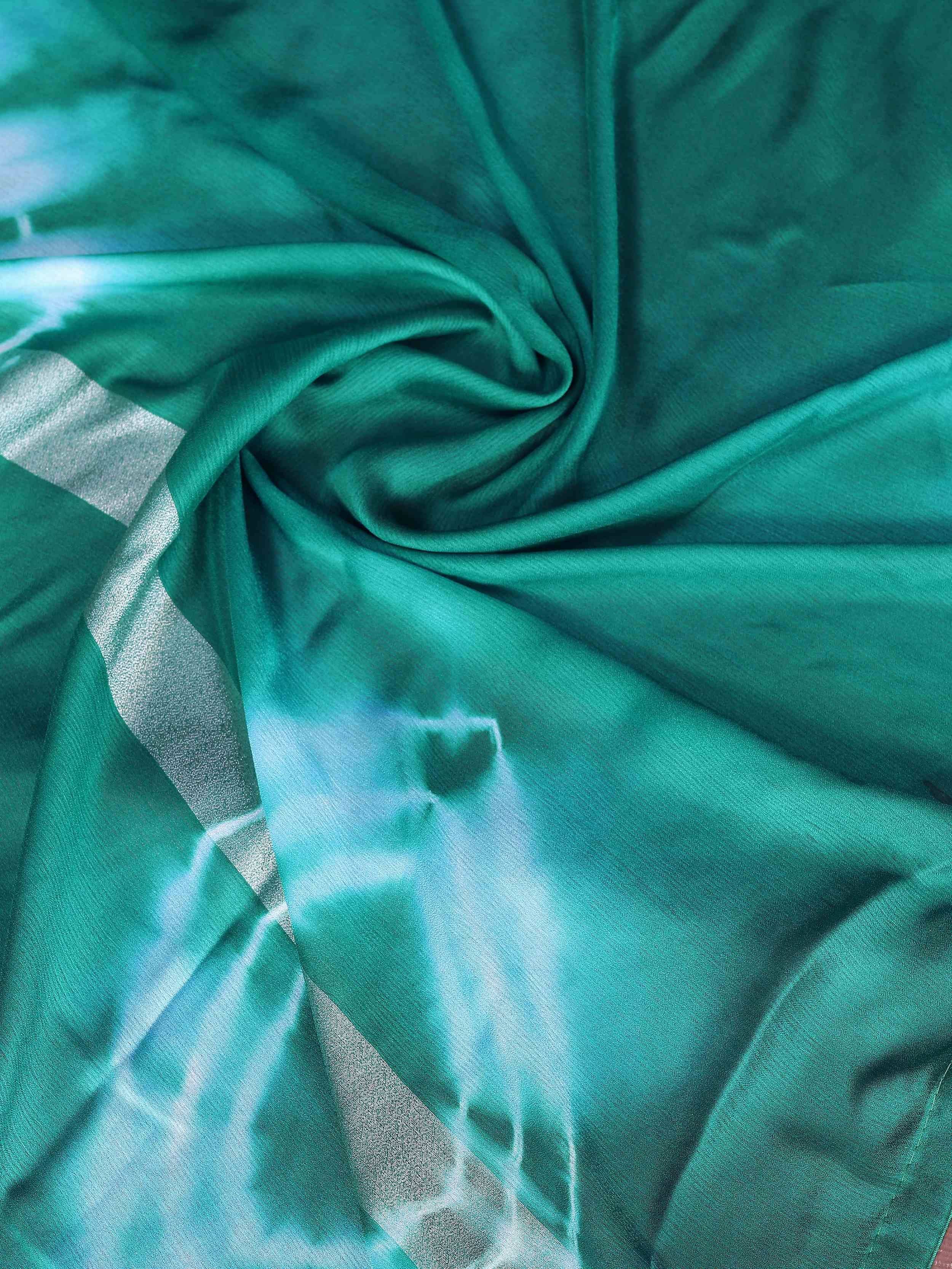 Emerald green ethnic saree with silver zari border and tie-dye pattern