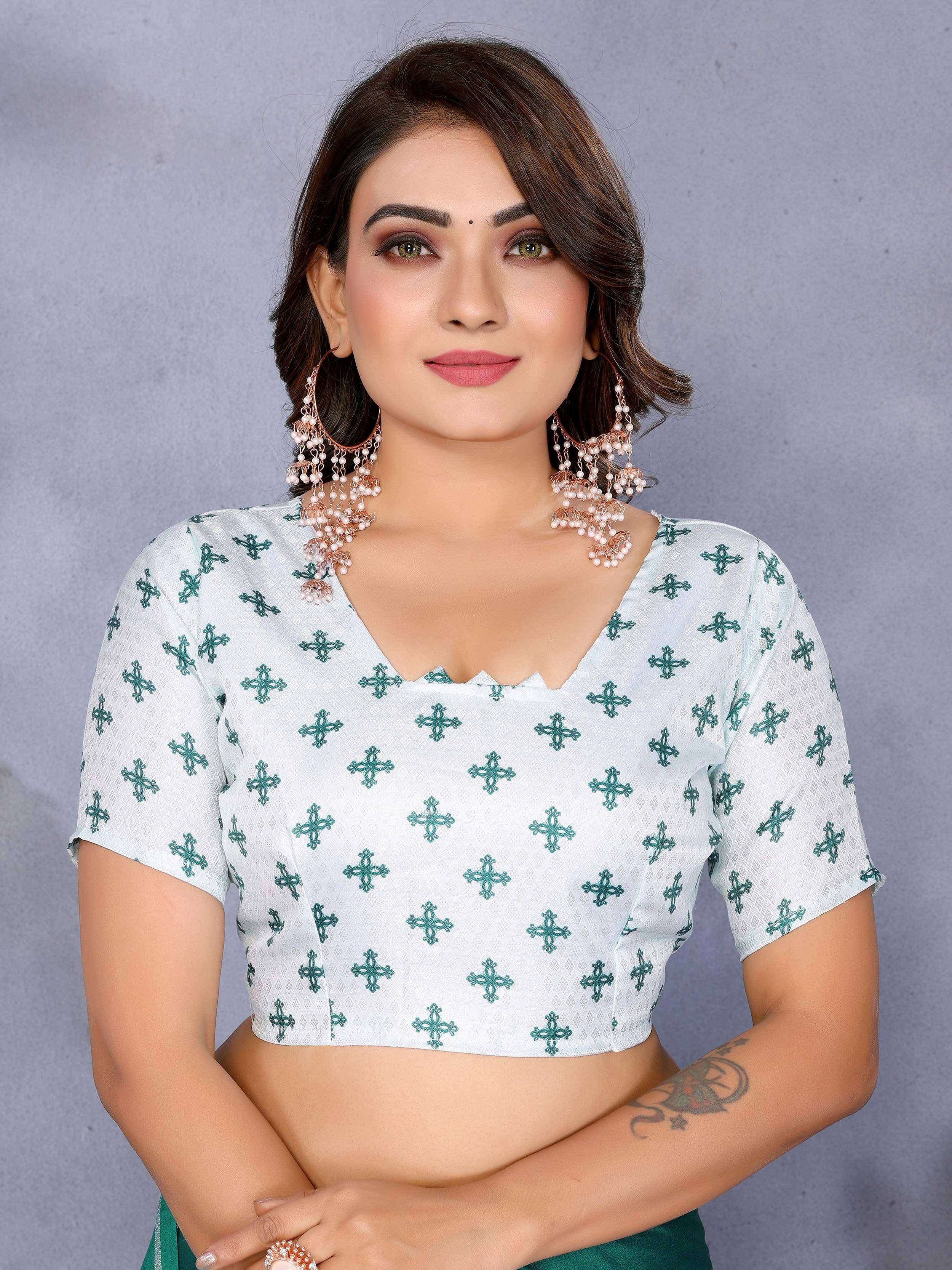 White crop top with green floral print, paired with ethnic jewelry for traditional Indian wear