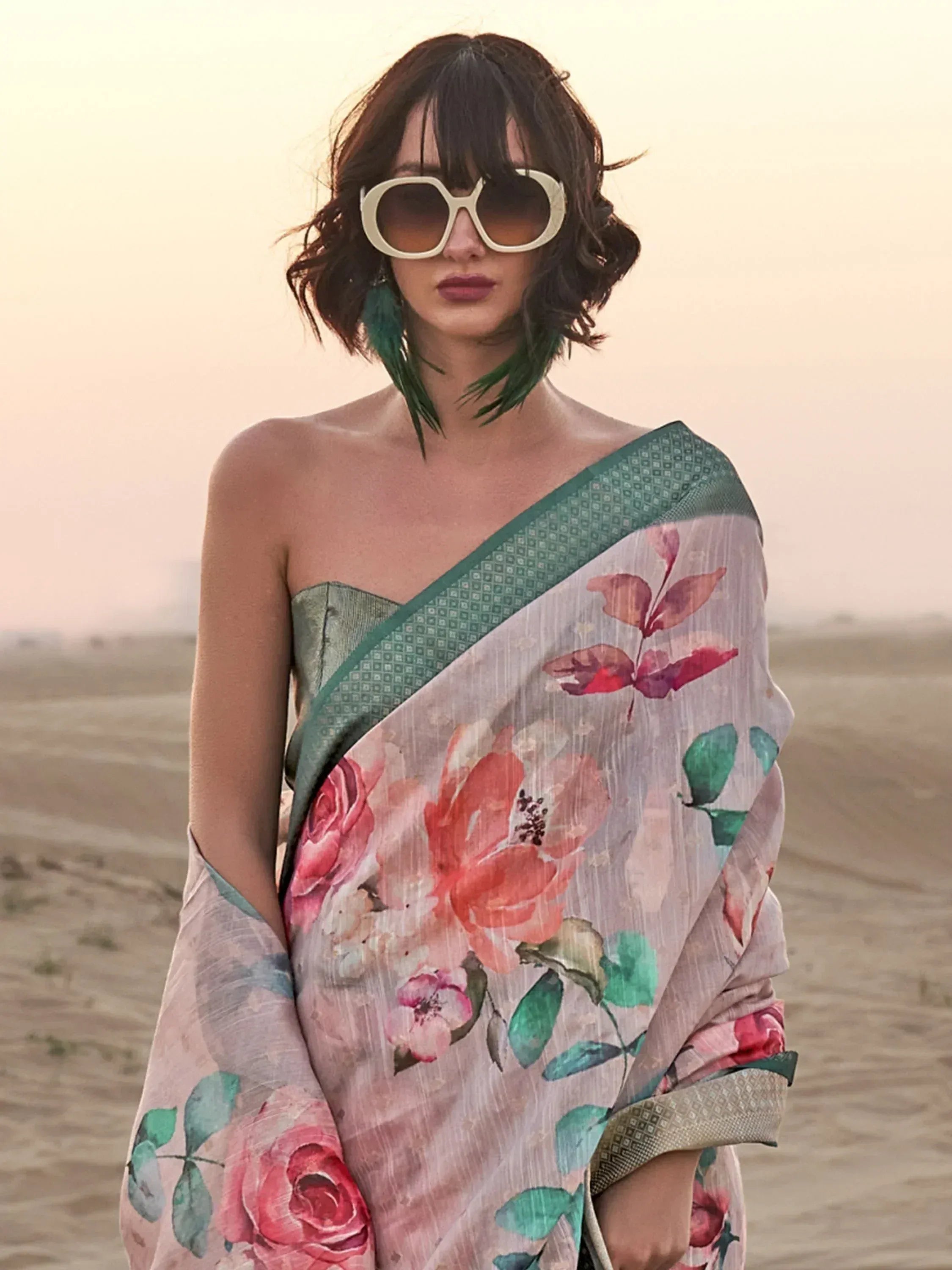 Floral print saree with green border, styled with sunglasses in desert setting