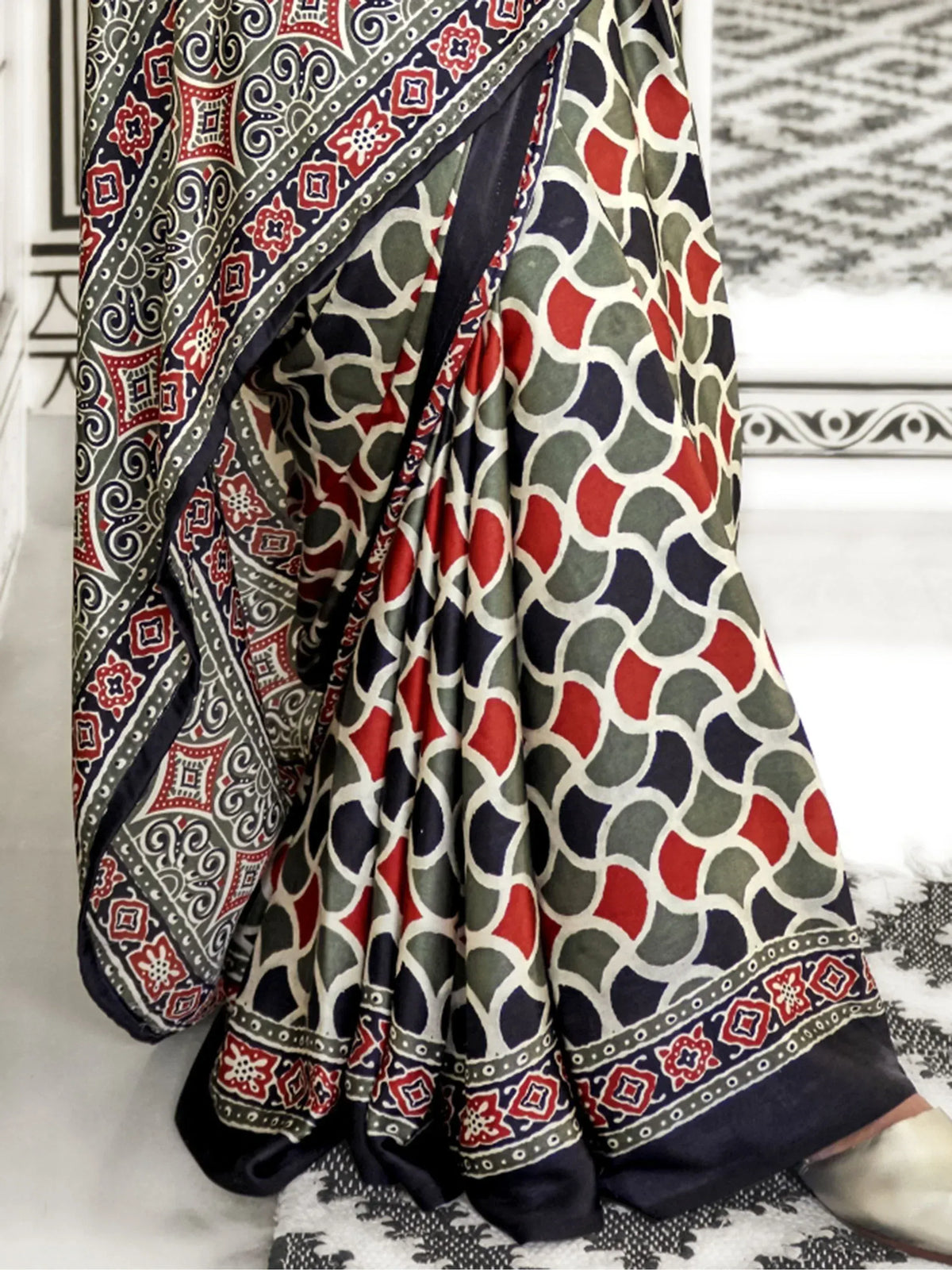 Ethnic printed saree with red, green, and navy geometric patterns, ideal for Indian traditional wear.