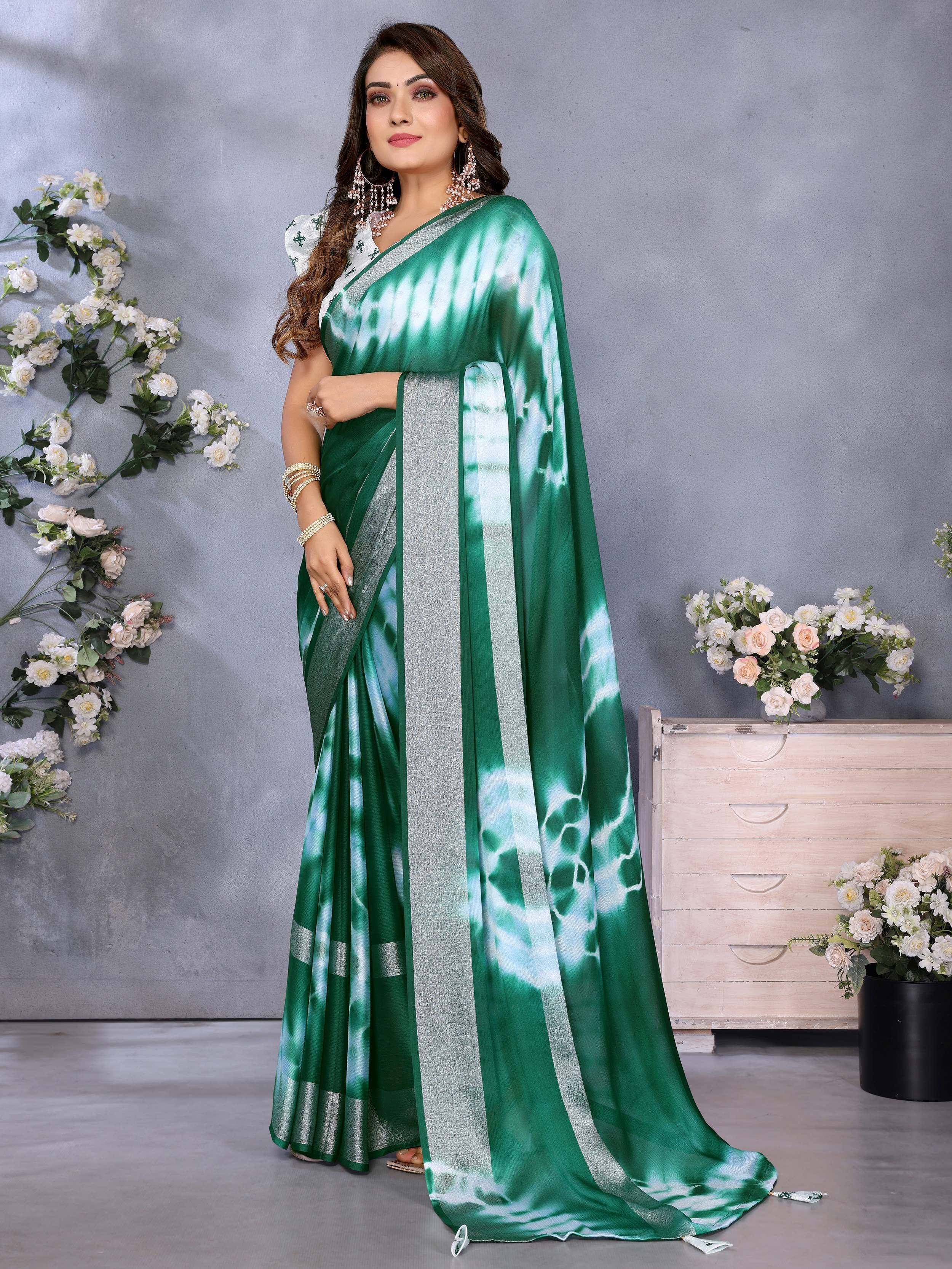 Green tie-dye saree with silver border, styled with white blouse and ethnic jewelry for festive occasions