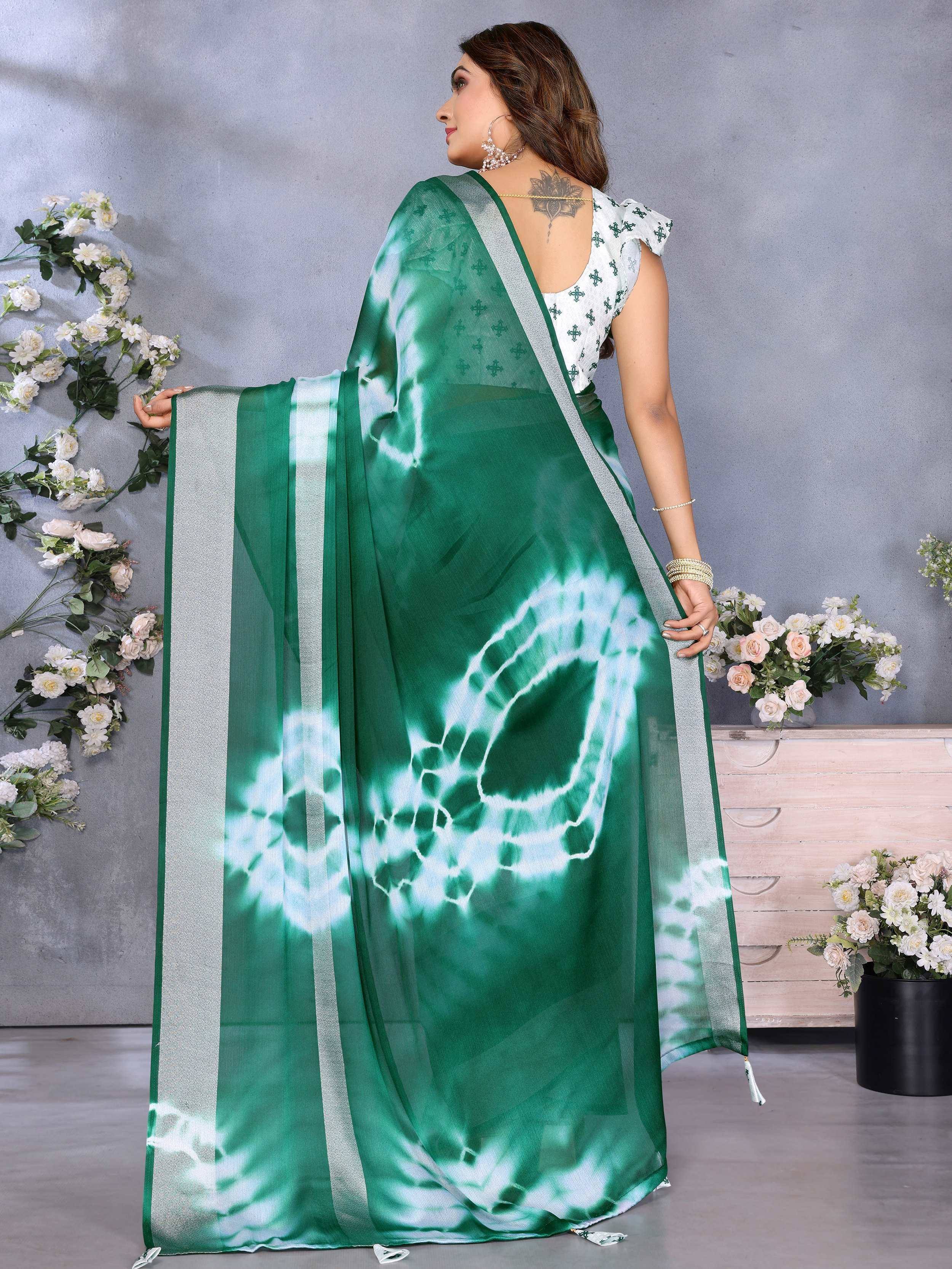 Green tie-dye saree with silver border, paired with printed blouse, ideal for ethnic occasions
