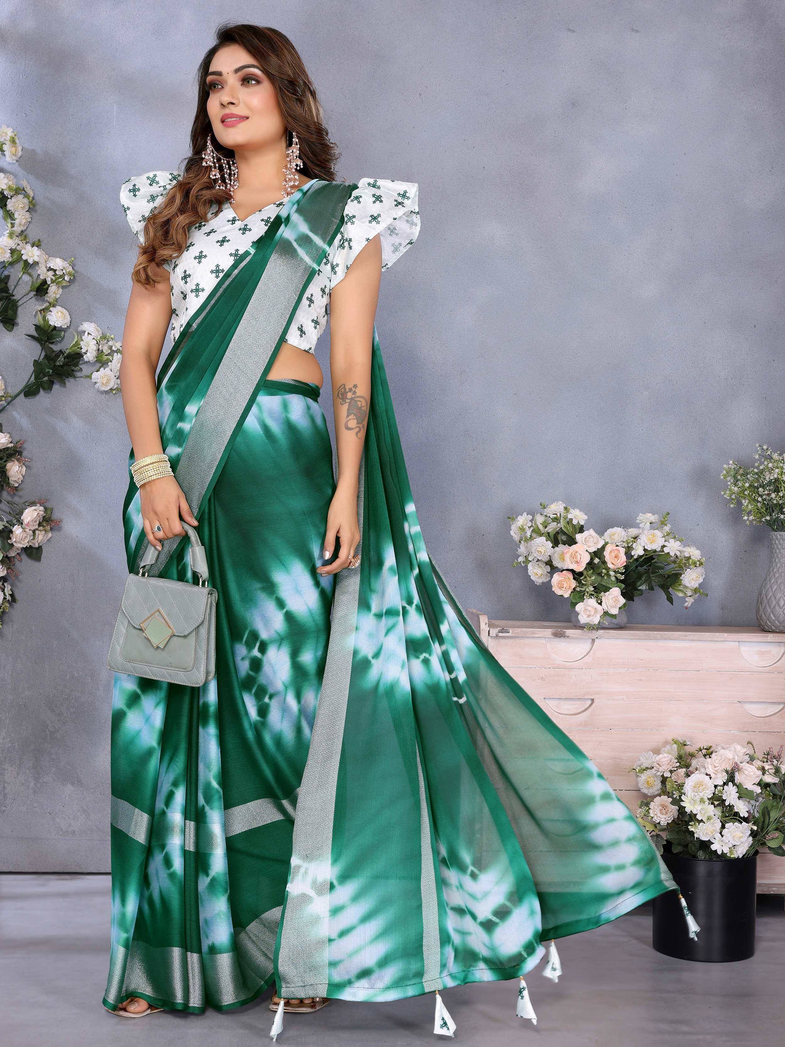 Green tie-dye saree with silver border, white printed blouse, and ethnic jewelry for Indian occasions