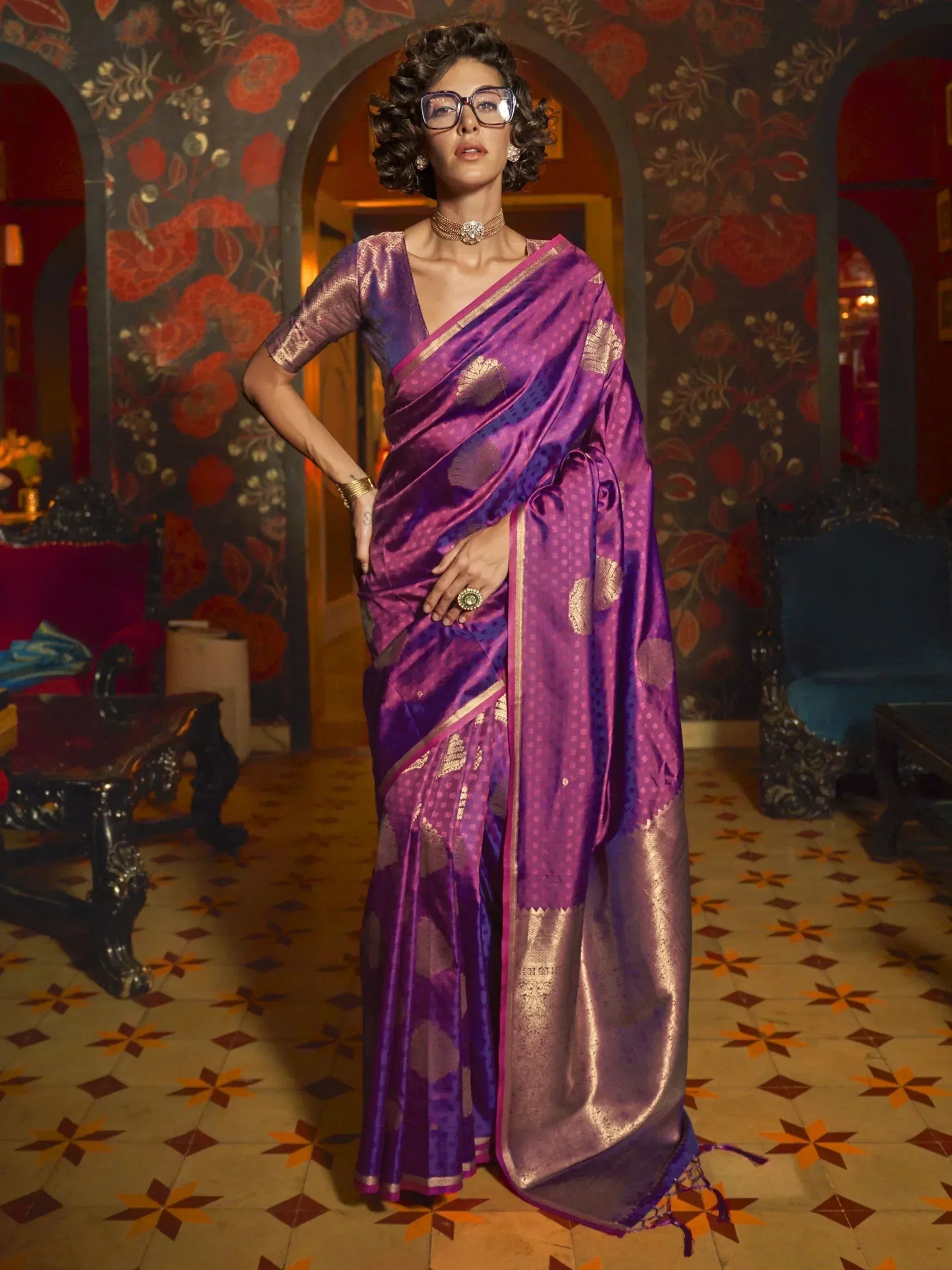 Woman in purple silk saree with gold motifs, ethnic Indian wear for festive occasions