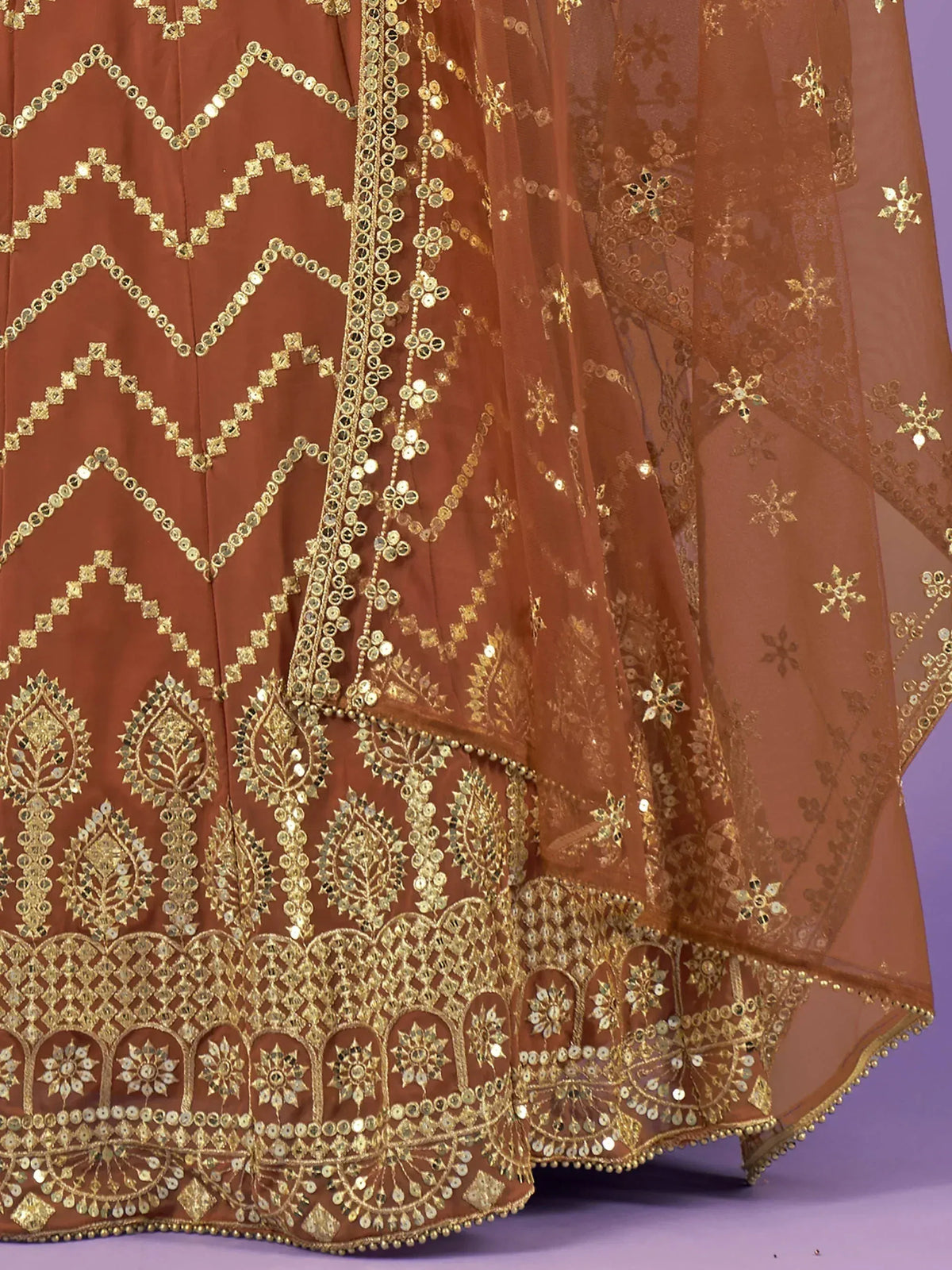 Elegant brown lehenga with gold embroidery and mirror work, perfect for Indian ethnic wear.