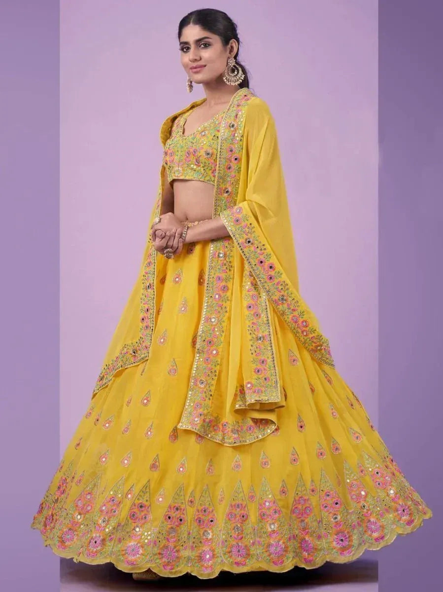 Yellow embroidered lehenga choli with floral motifs, perfect for Indian ethnic wear and festive occasions