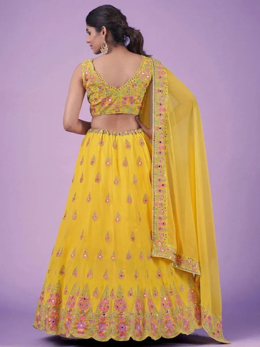 Yellow embroidered lehenga choli with floral motifs and matching dupatta, ideal for Indian ethnic wear occasions