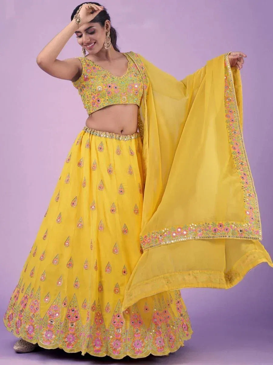 Yellow embroidered lehenga choli with floral motifs and matching dupatta, ideal for Indian ethnic occasions