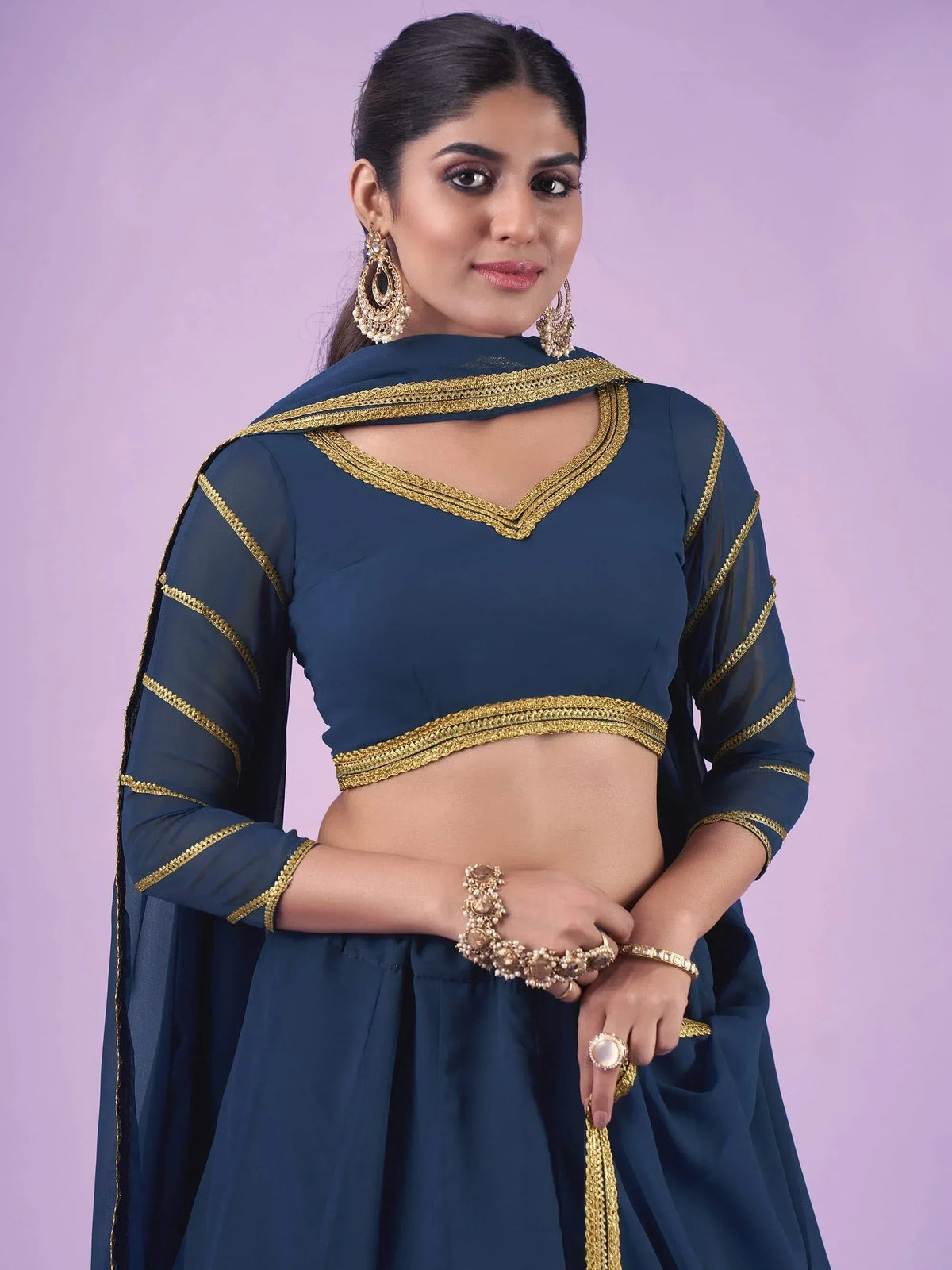 Elegant navy blue ethnic wear with gold embroidery and matching jewelry
