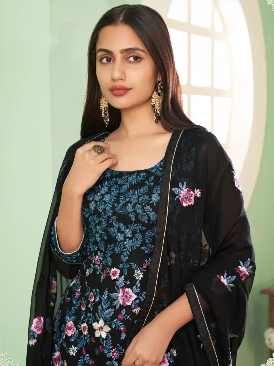 Woman in black floral embroidered ethnic suit with dupatta, traditional Indian attire