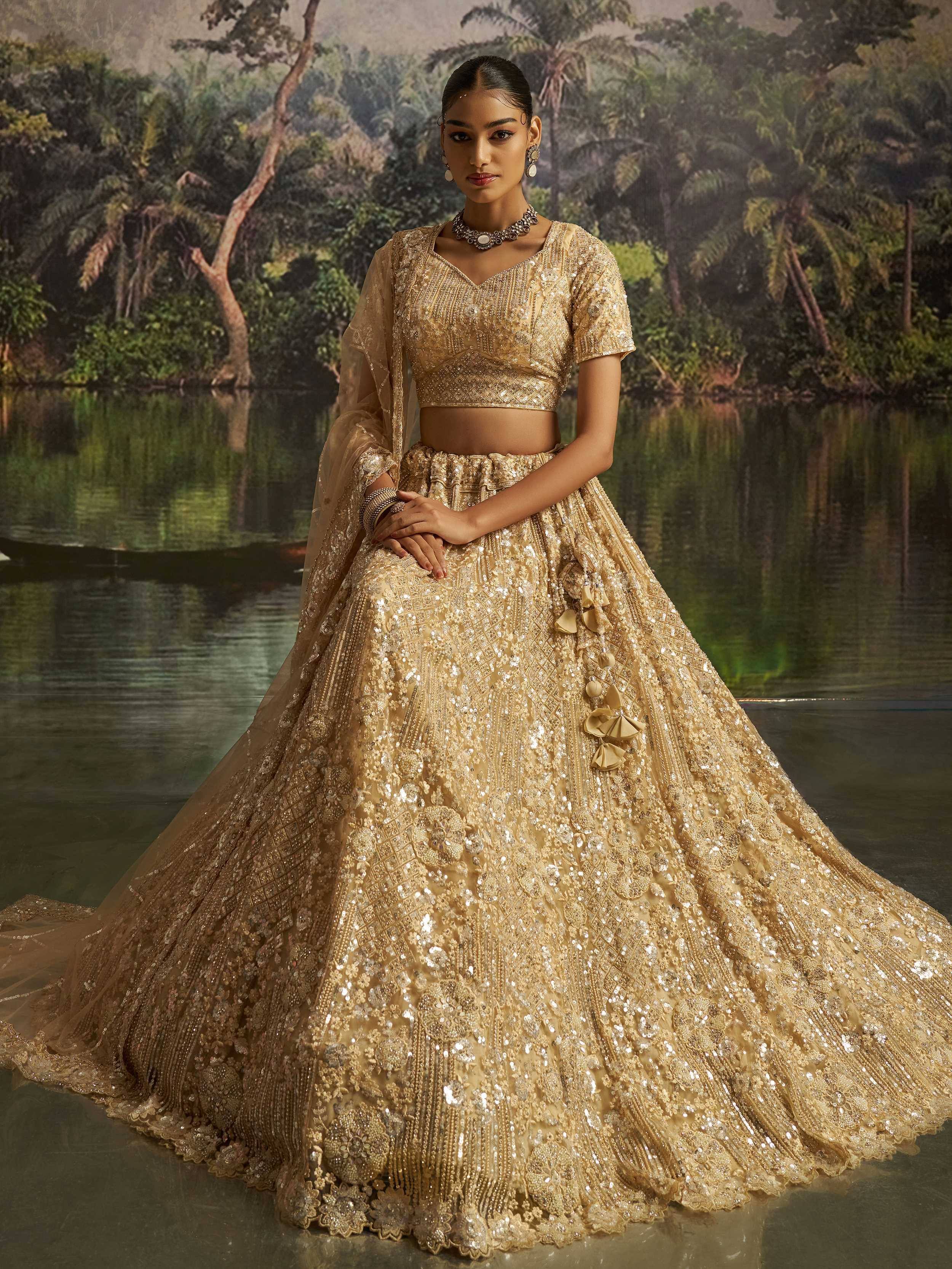 Golden embroidered lehenga choli with sequins, perfect for Indian weddings and festive occasions.