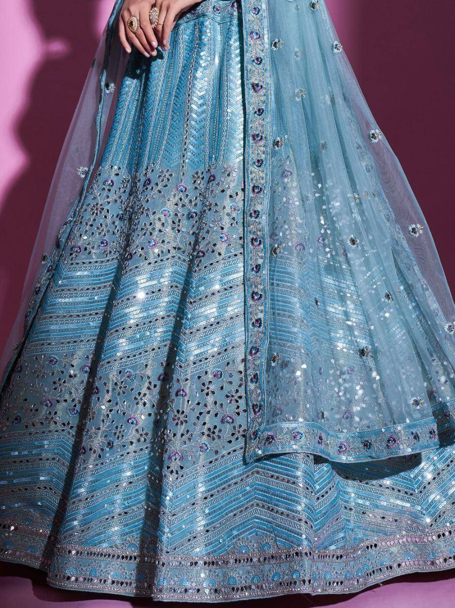 Light blue designer lehenga choli with intricate embroidery and sequin work, perfect for Indian ethnic wear.