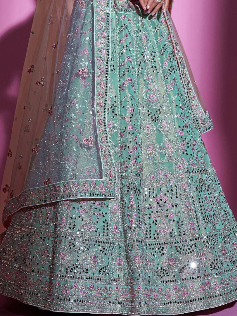 Mint green designer lehenga with pink floral embroidery and mirror work, perfect for Indian ethnic wear.