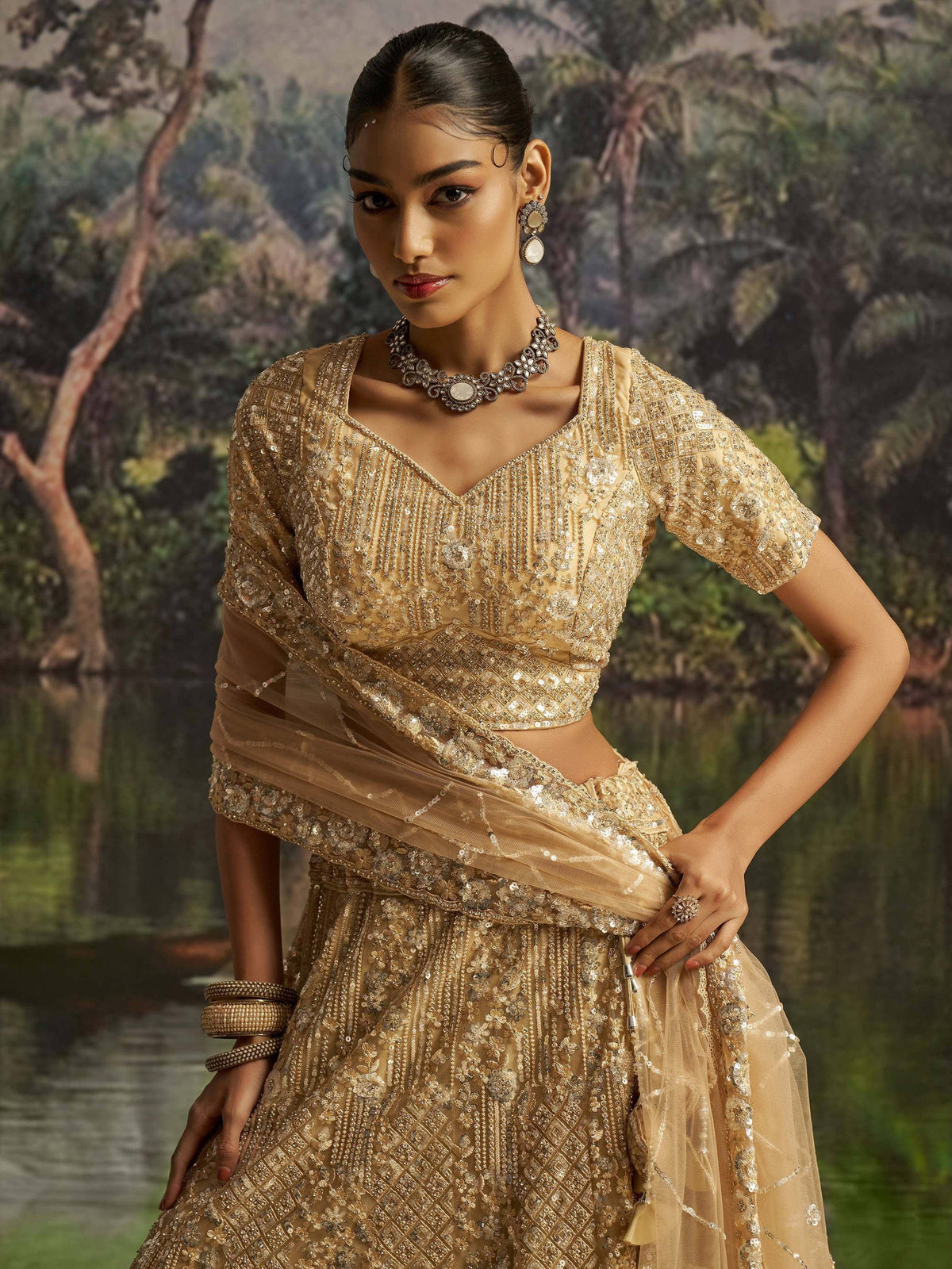 Golden embroidered lehenga choli with sequins, perfect for Indian weddings and festive occasions.
